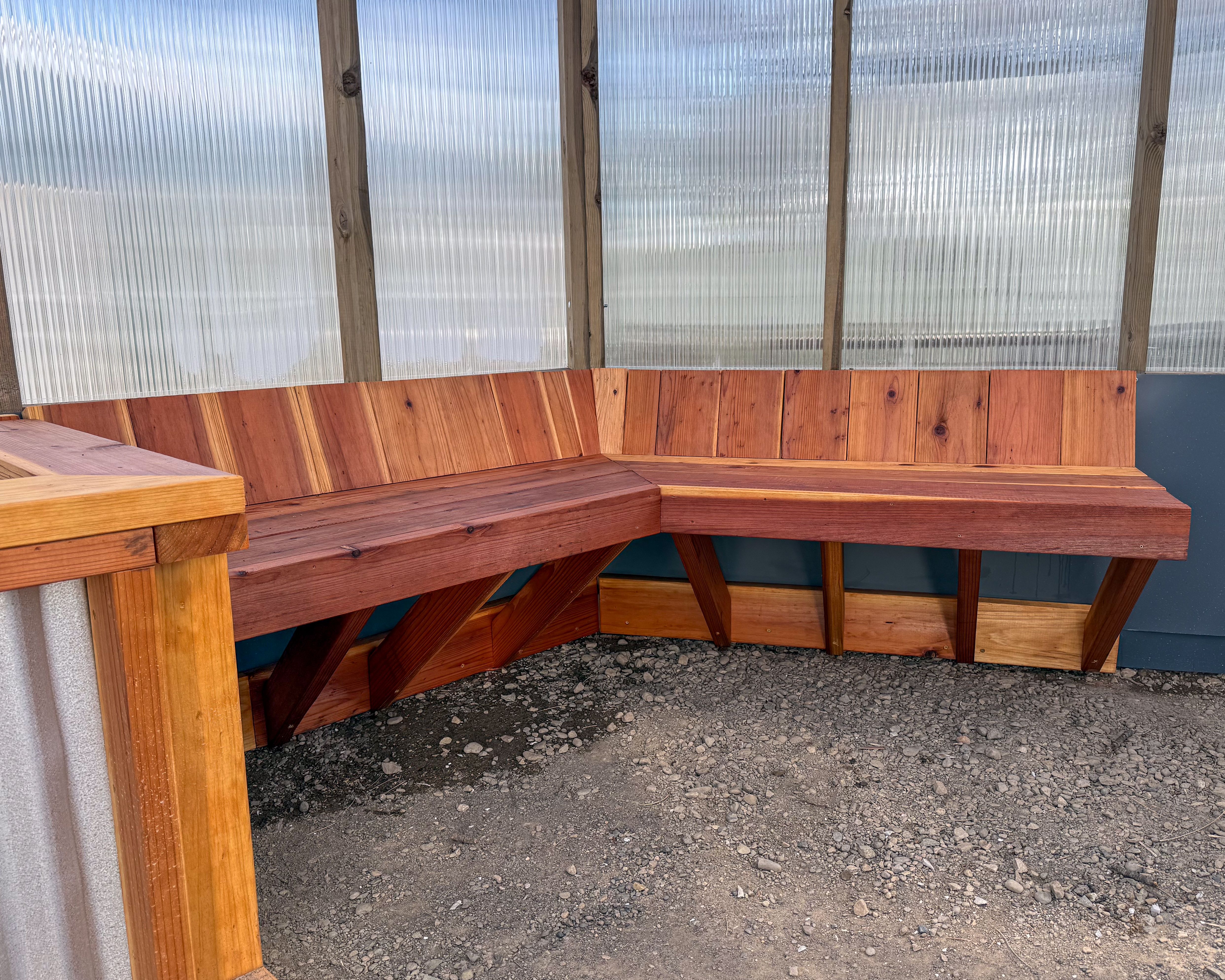 Custom built-in redwood bench in a greenhouse