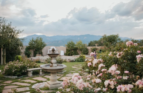 Rose garden with water fountain and mountain backdrop at Hillside gardens