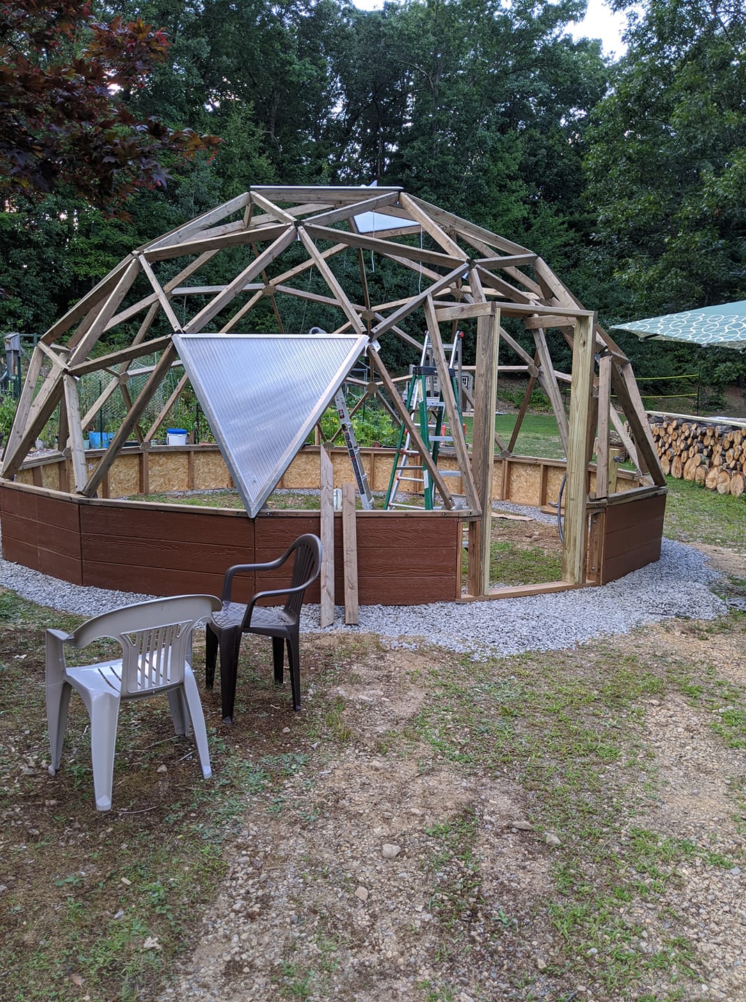 Triangular vent panel being installed in a Growing Dome frame in New Hampshire