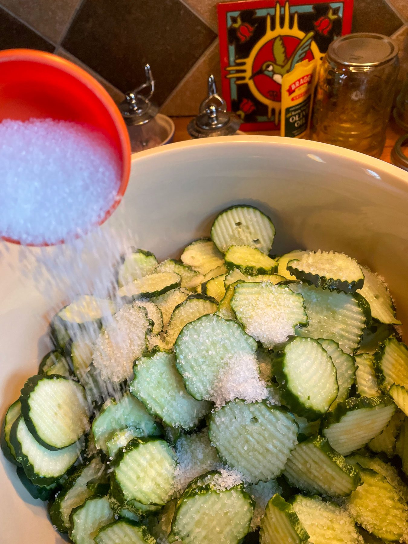 sprinkling salt onto cucumber slices for pickling