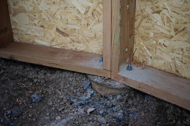 Wooden Growing Dome wall section anchored to a concrete pier