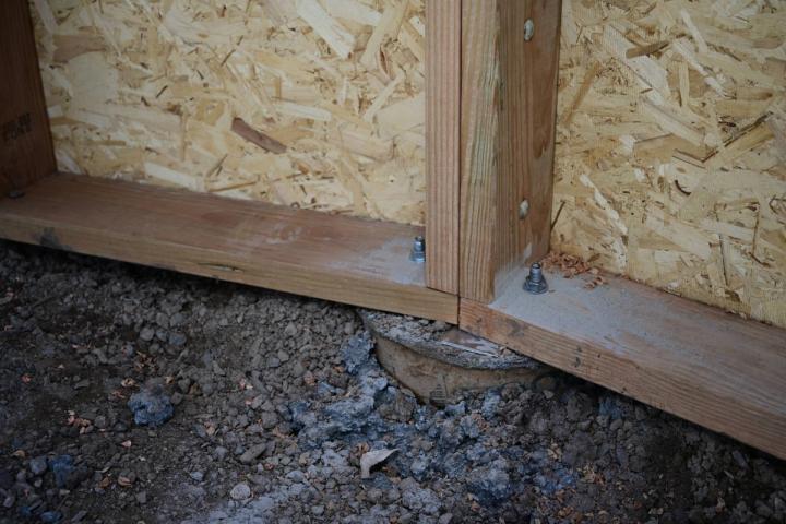 Two wooden all sections of a growing dome greenhouse anchored to a concrete pier