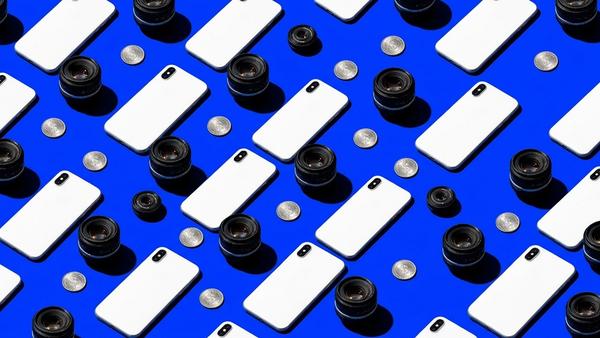 White smartphones and lenses in a diagonal pattern representing AI UGC video production.