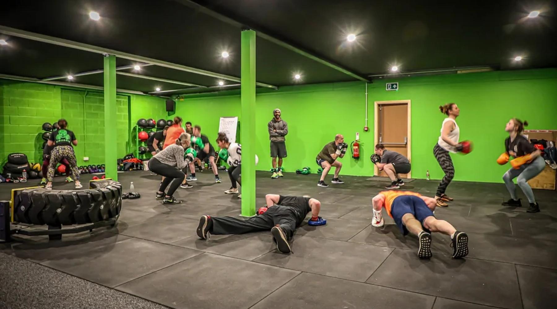 Boxing for beginners: members training with boxing gloves and pads at TNT Fitness, Cowan Bridge
