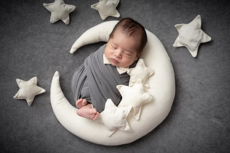 Photo of a newborn in gray clothes