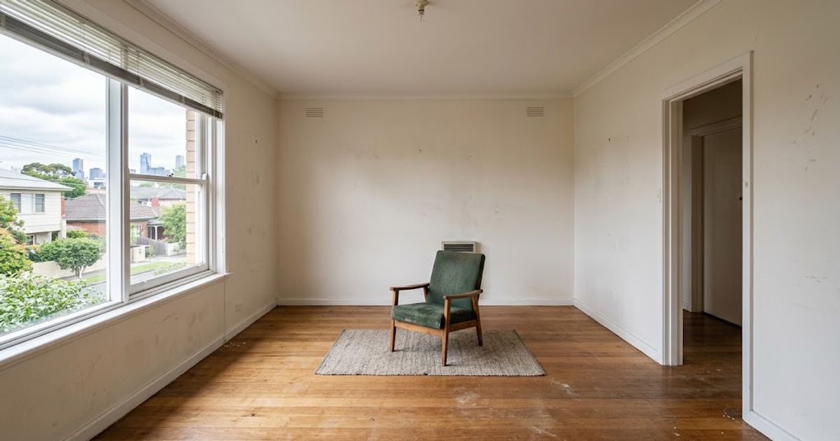 An empty Melbourne rental unit at the end of a lease with one leftover piece of furniture in an otherwise cleared room