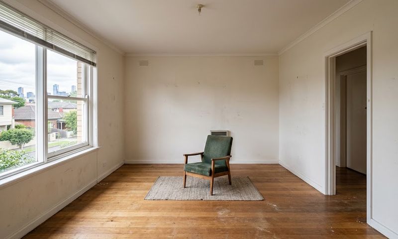 An empty Melbourne rental unit at the end of a lease with one leftover piece of furniture in an otherwise cleared room