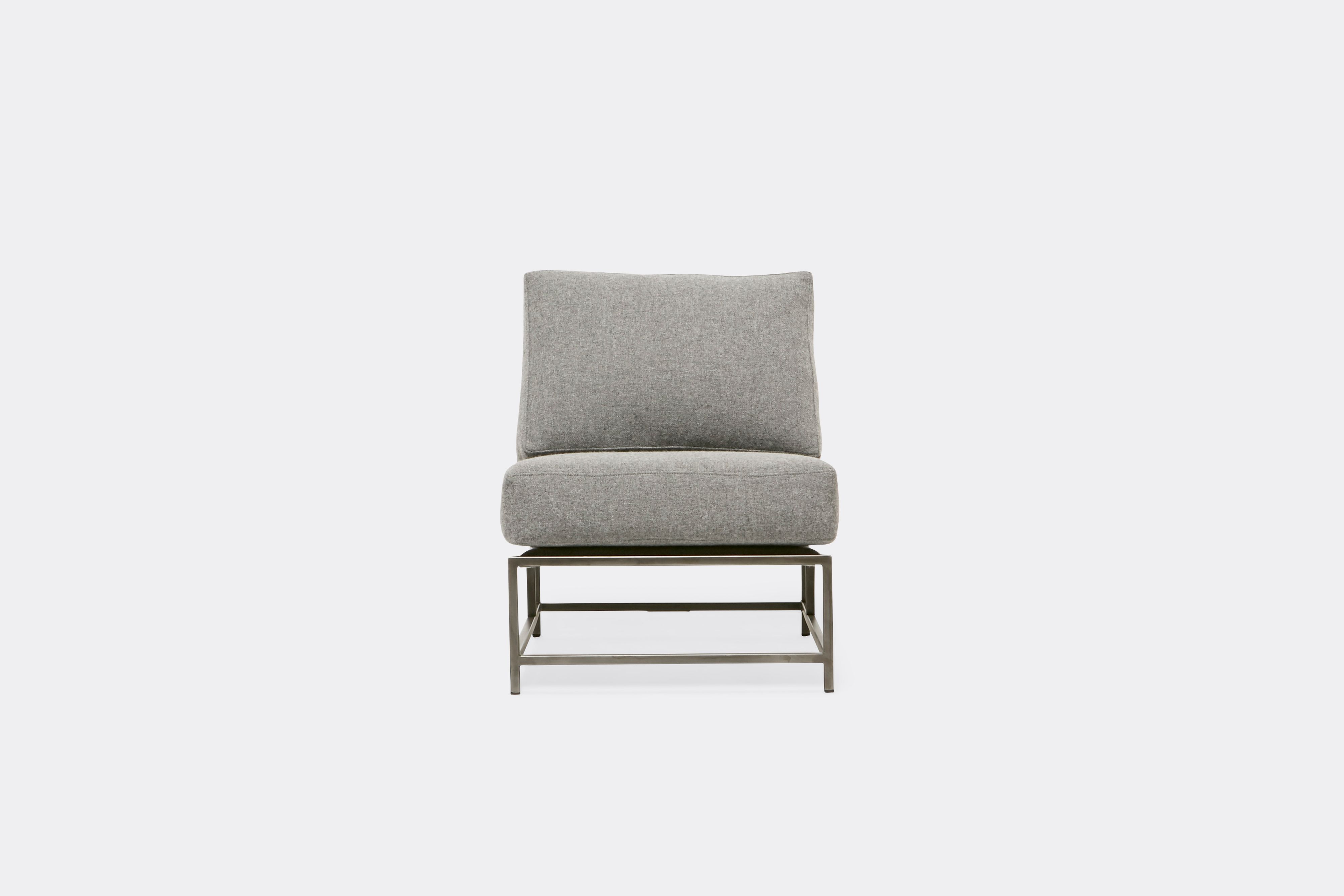 Front view of lounge chair with grey wool upholstery and antique nickel metal frame