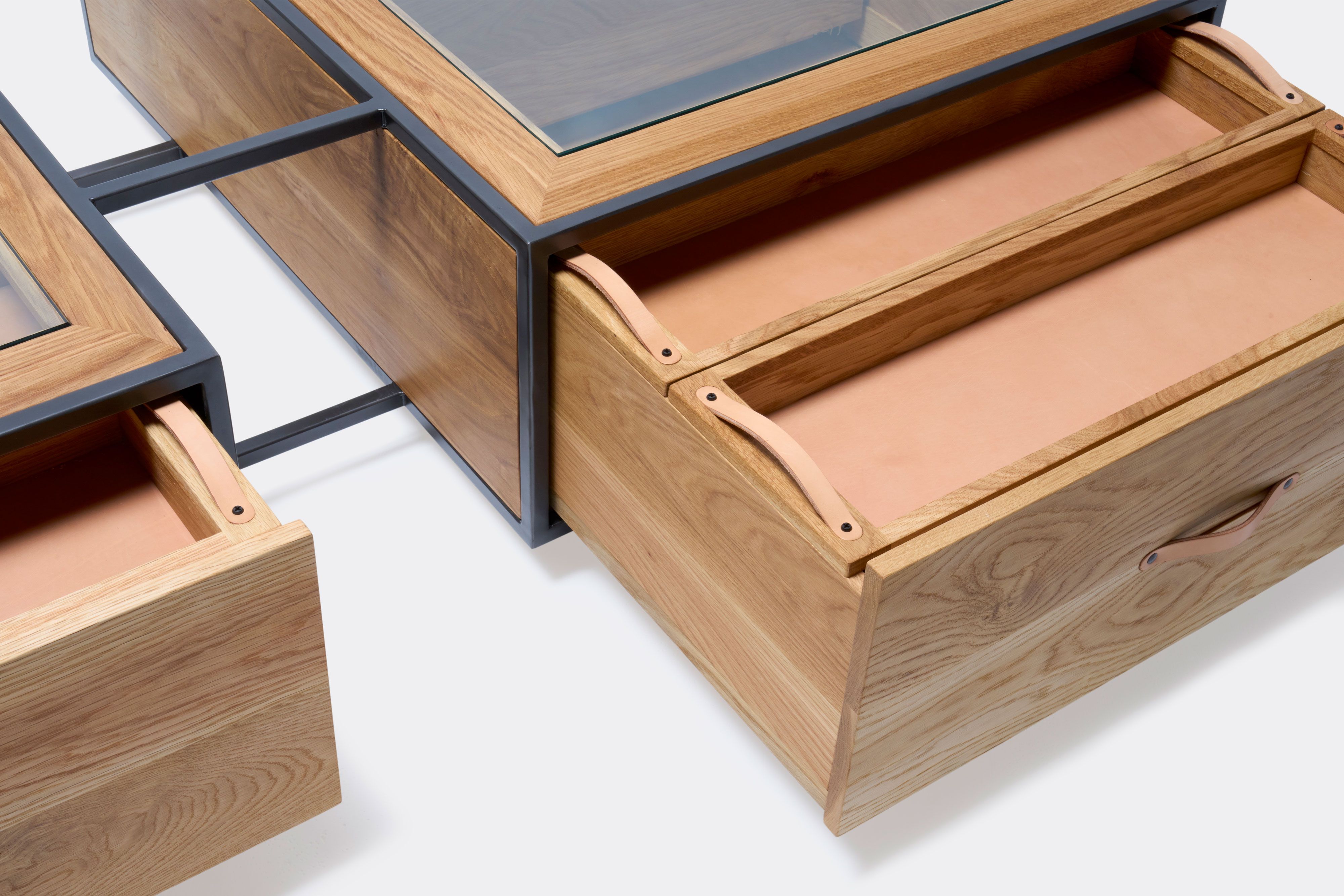 detail of double display coffee table with white oak wood, blackened steel metal and glass top