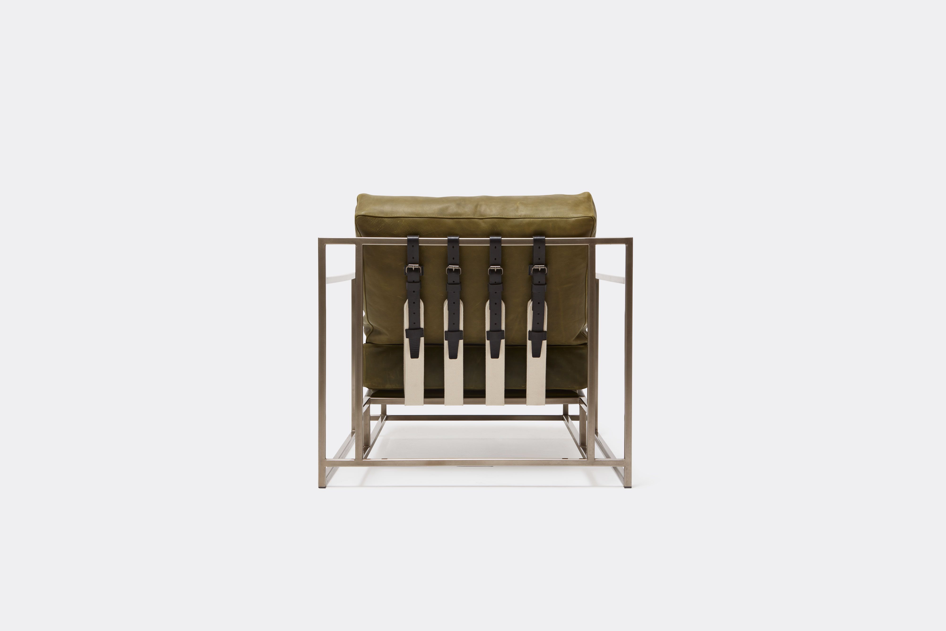 Back view of green leather chair with antique nickel frame and leather belts