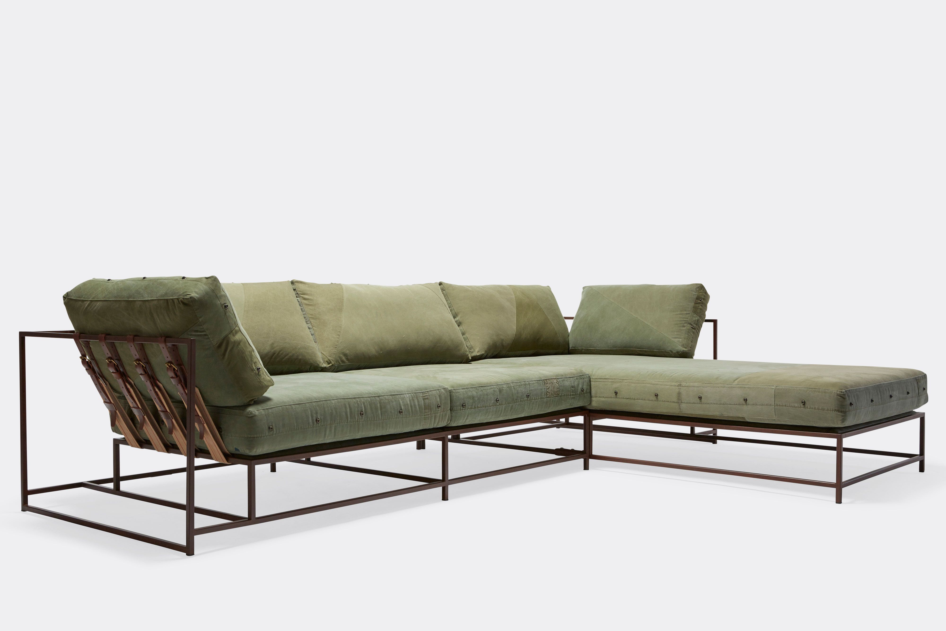 a green sectional couch with a chaise lounge on a white background .