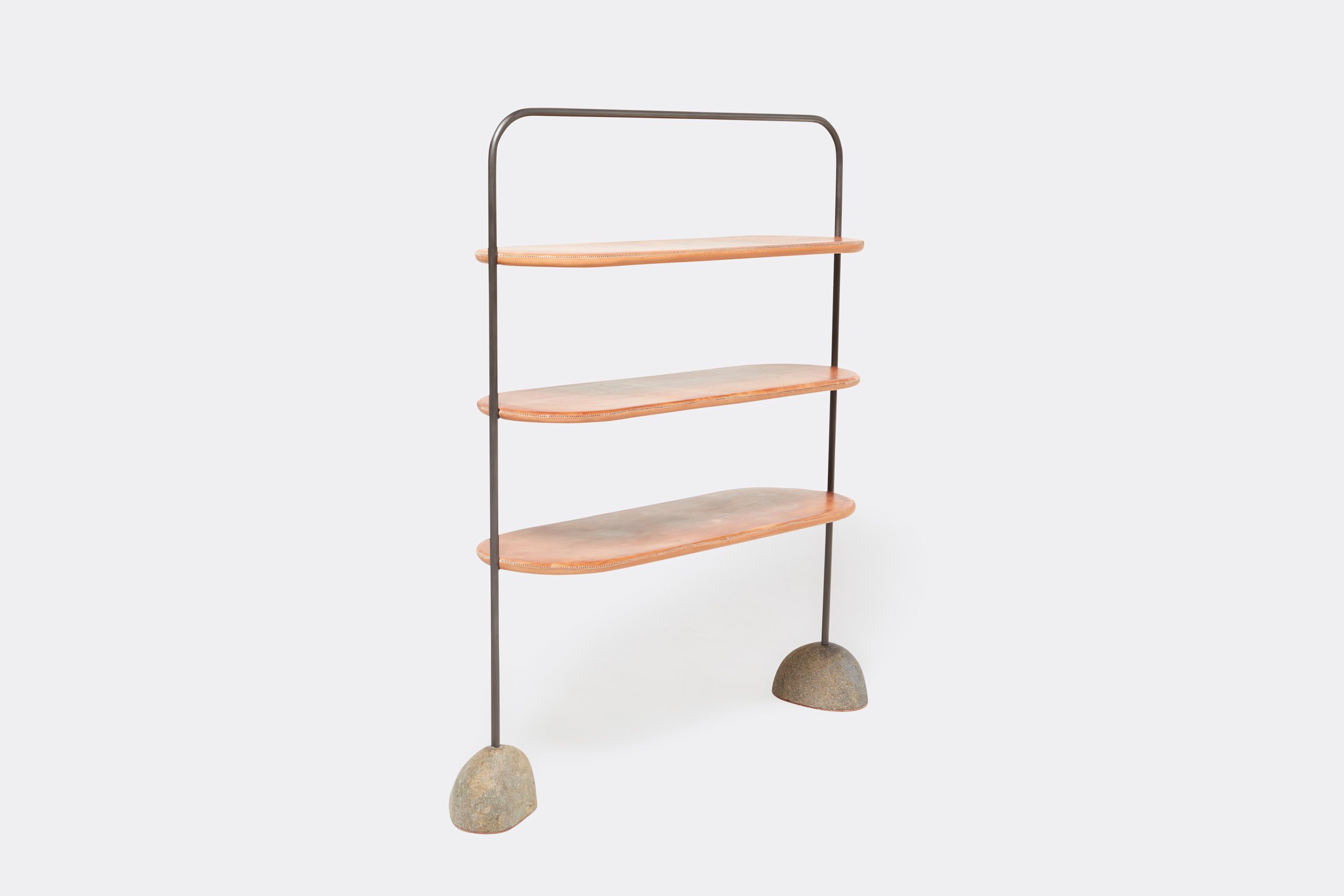 A leather wrapped steel framed shelf with stone bases. Shown on a white background with accent stones