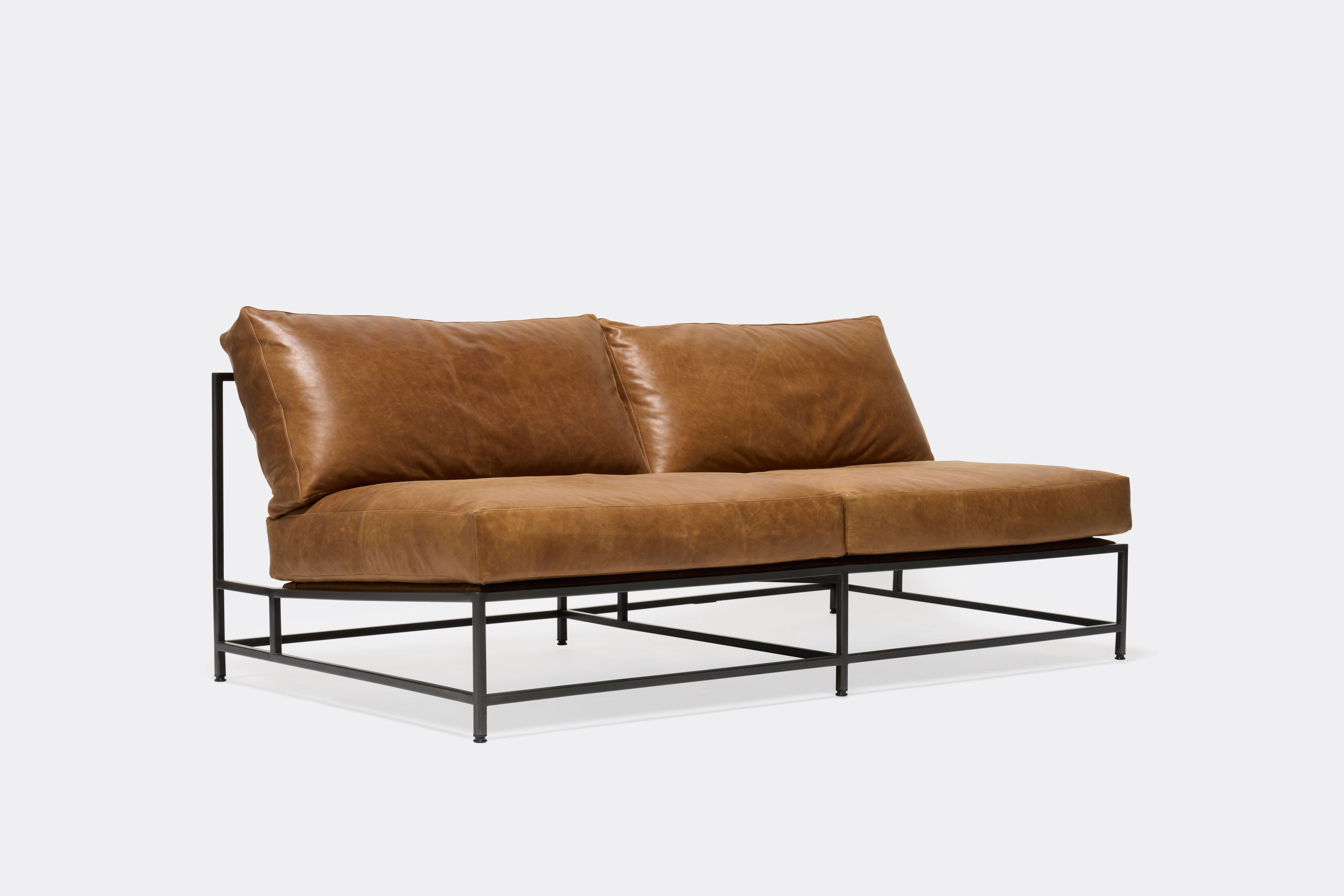 front of loveseat with brown leather upholstery on black metal frame