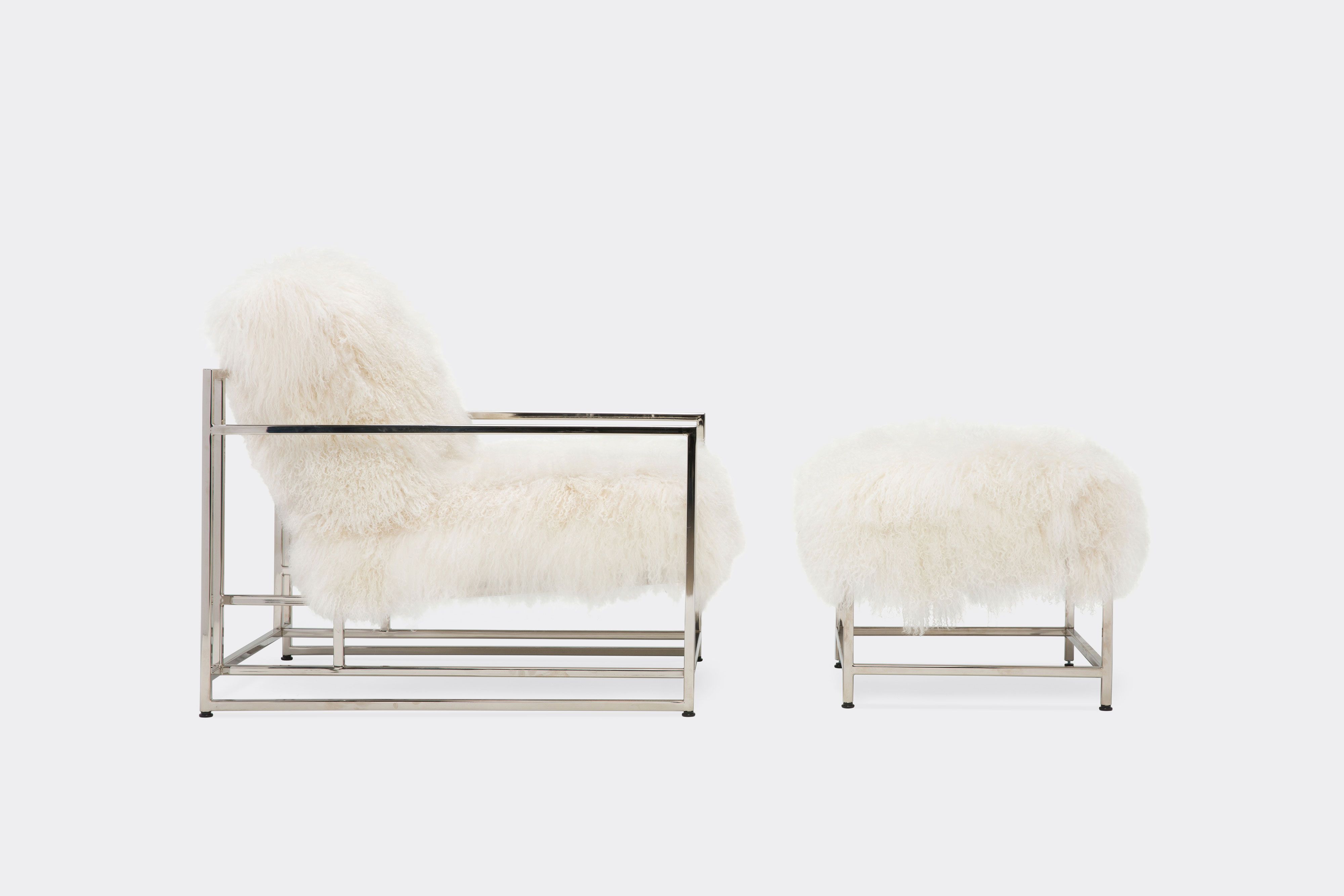 a white sheepskin armchair with black supporting belts on the back is sitting on a white surface .