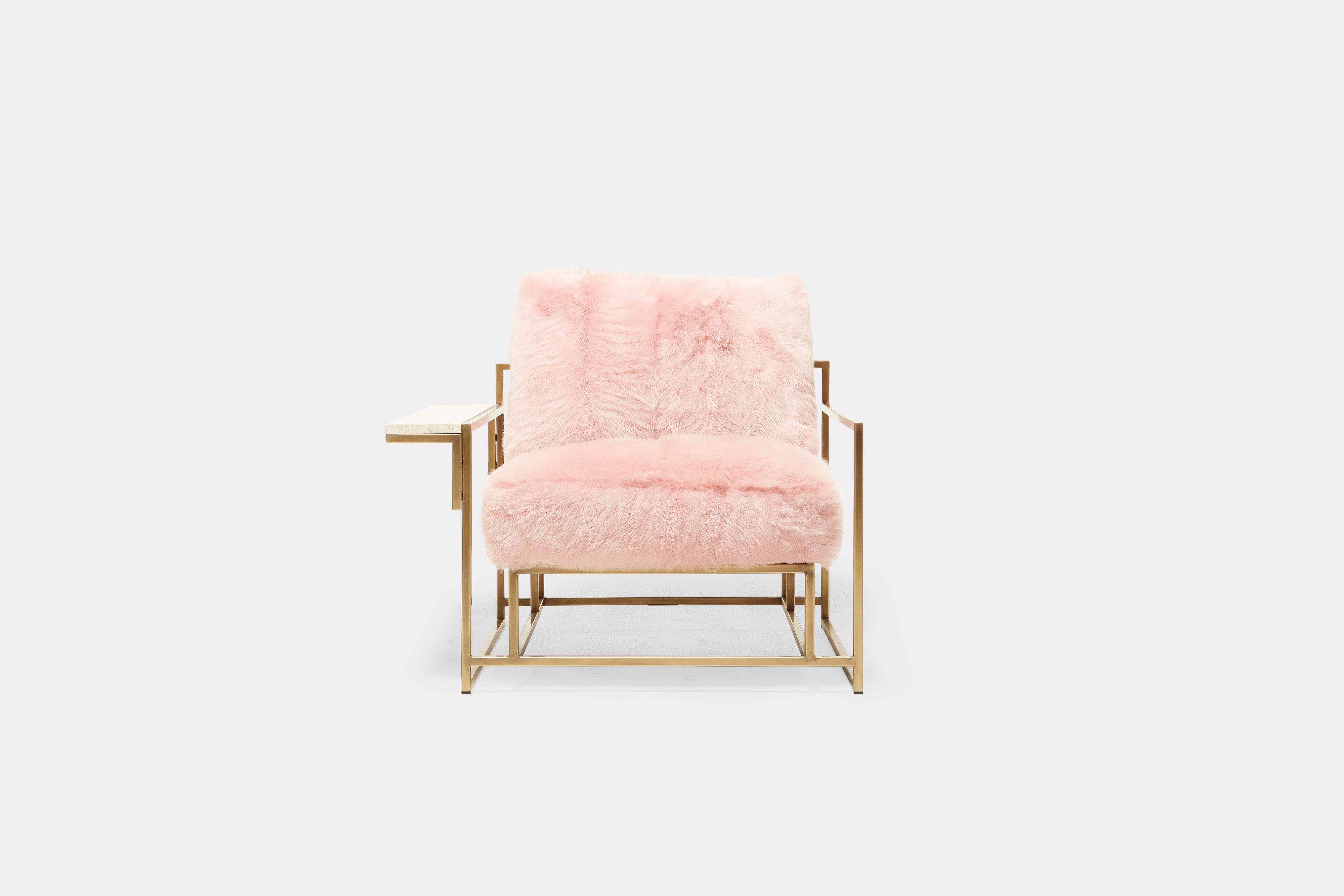 front of armchair with pink shearing upholstery on antique brass metal frame