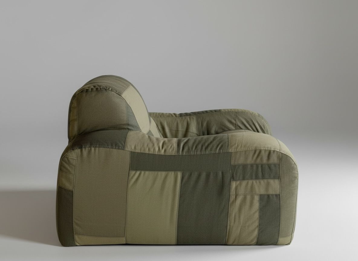 A plush, rounded green patchwork armchair.
