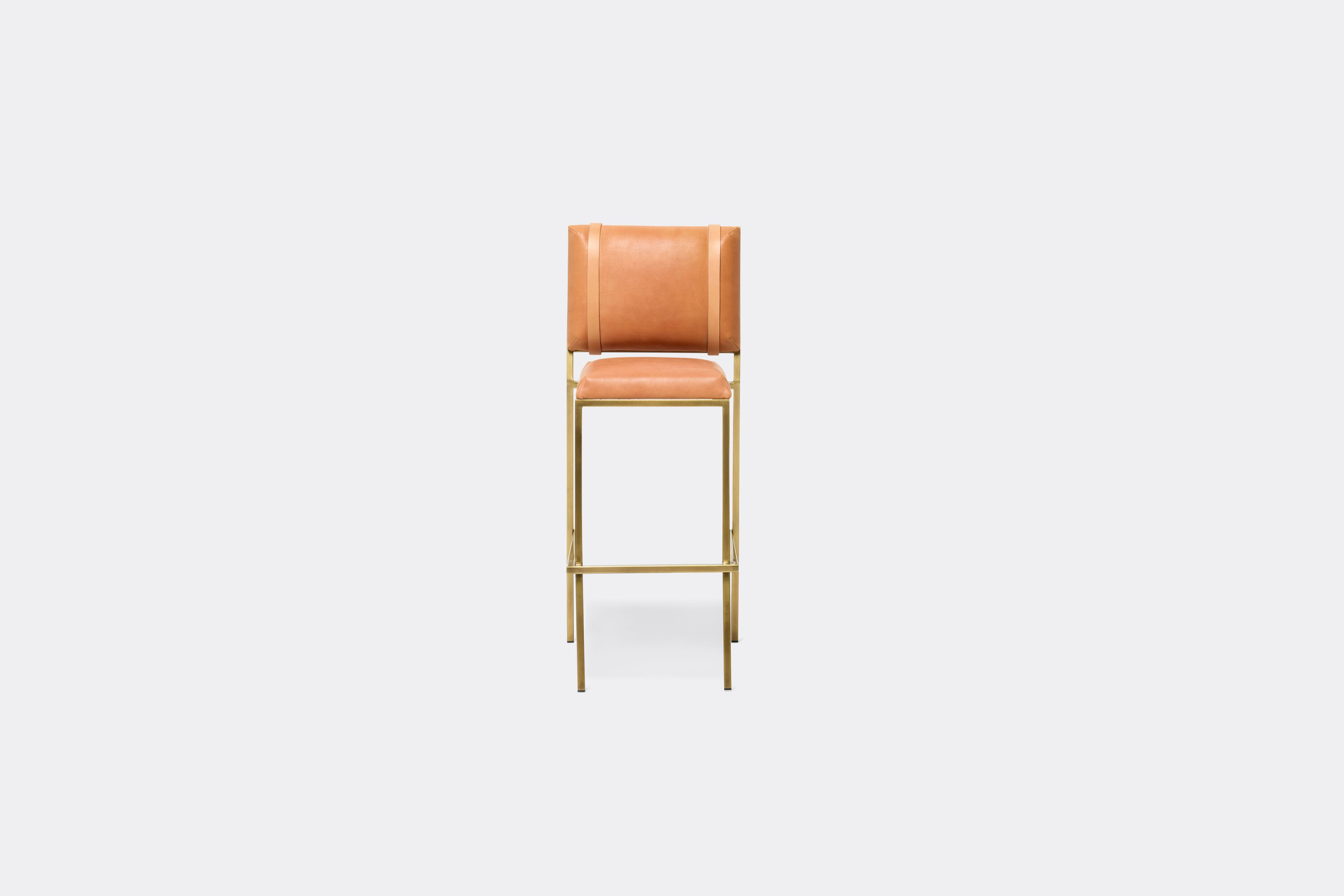 front view of veg tan leather barstool with antique brass metal frame