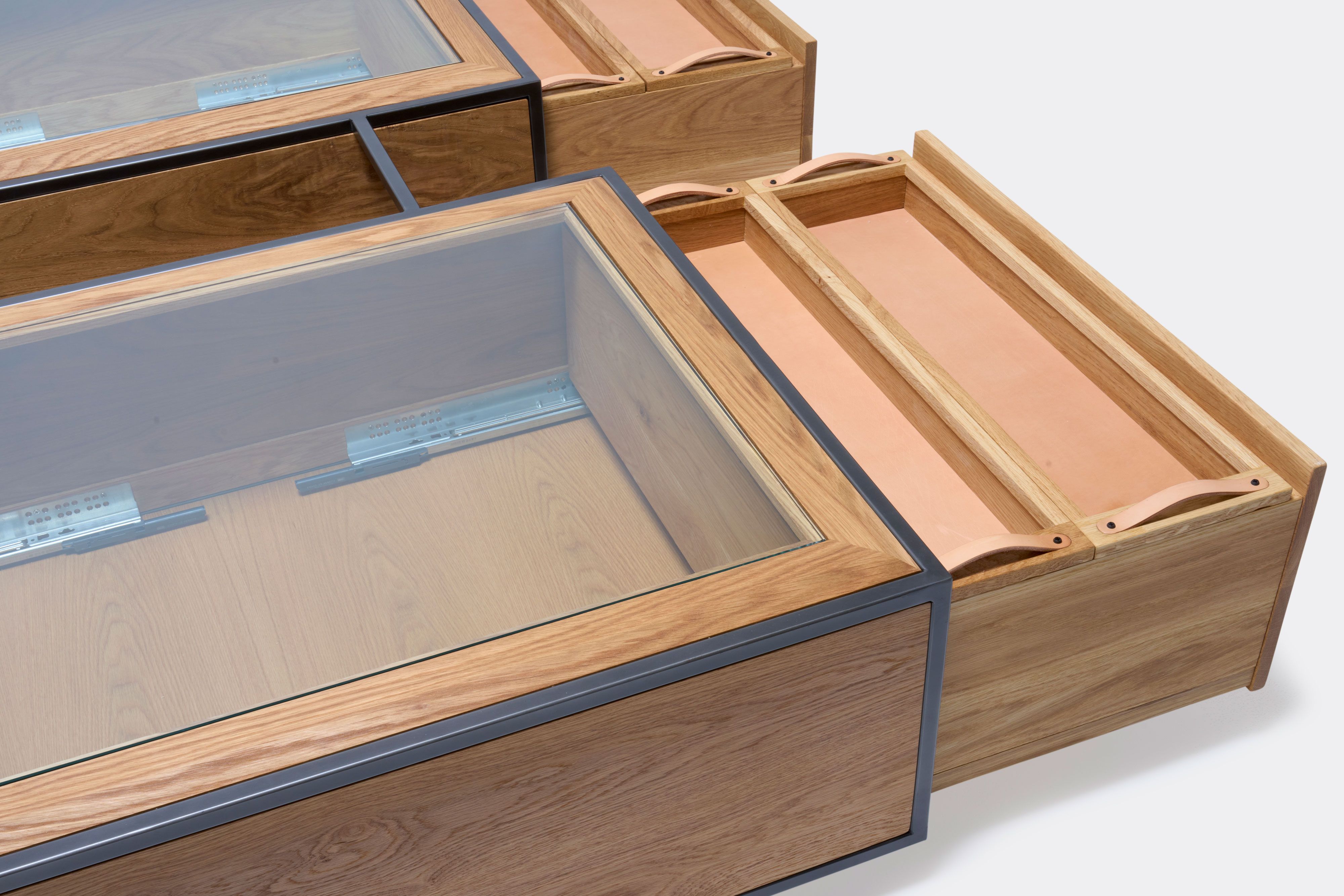 detail of double display coffee table with white oak wood, blackened steel metal and glass top