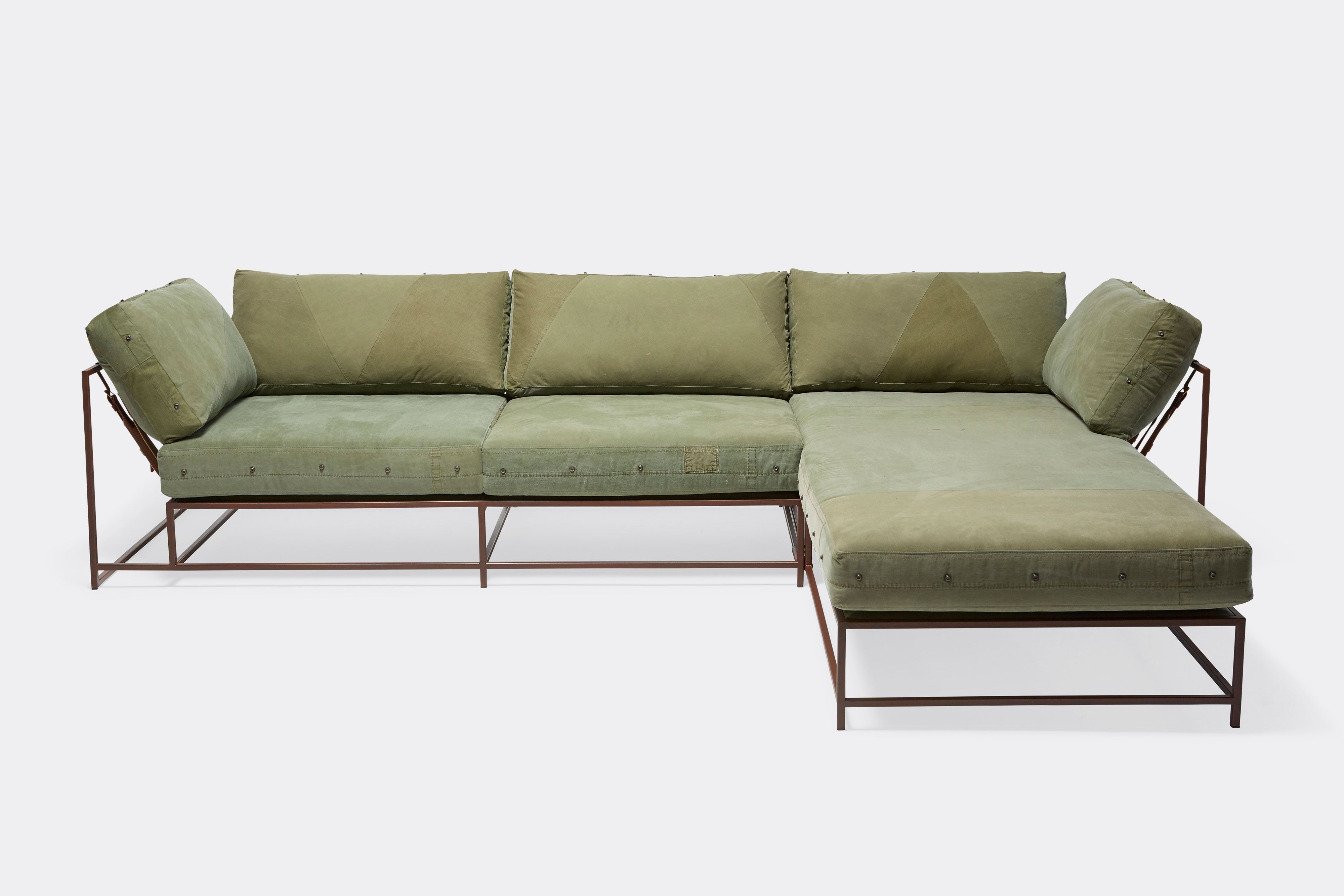 front of sectional with green canvas upholstery on marble rust metal frame
