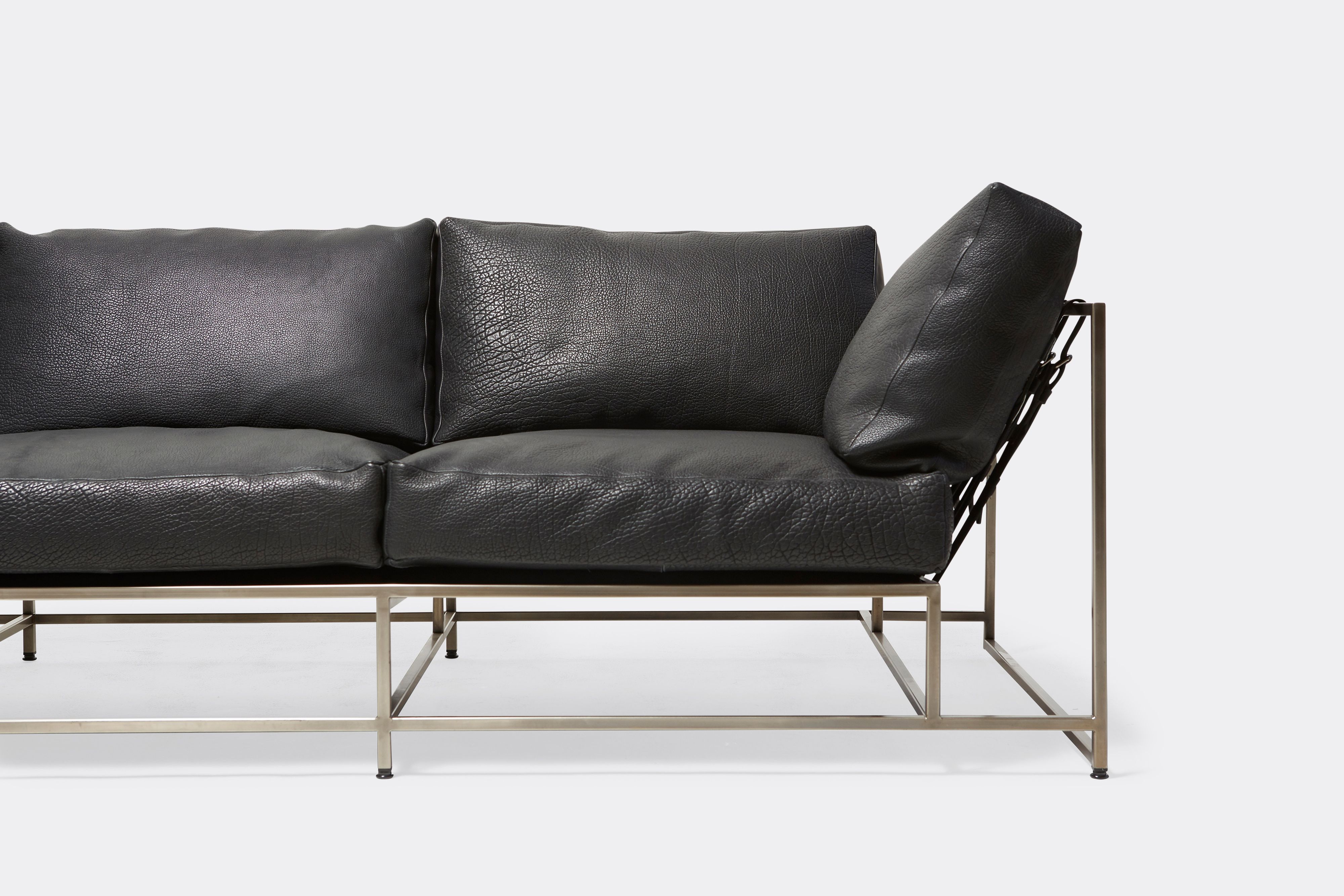 front of Sofa with black leather upholstery and antique nickel metal frame