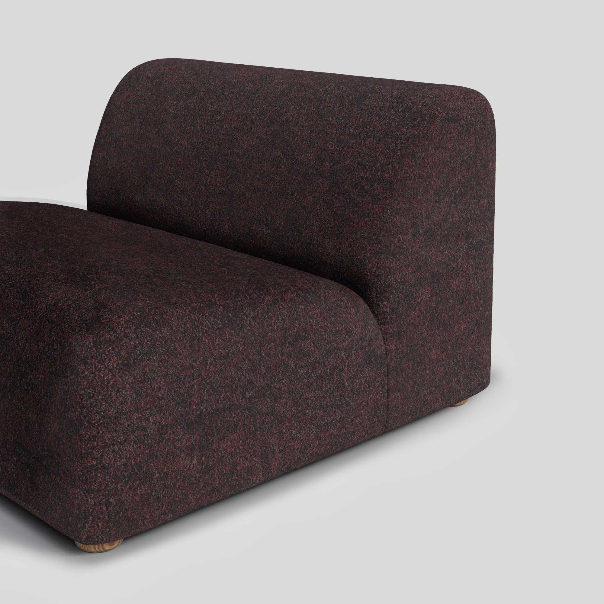 A modern, dark maroon modular sofa section with textured fabric, rounded back, and a small wooden leg.