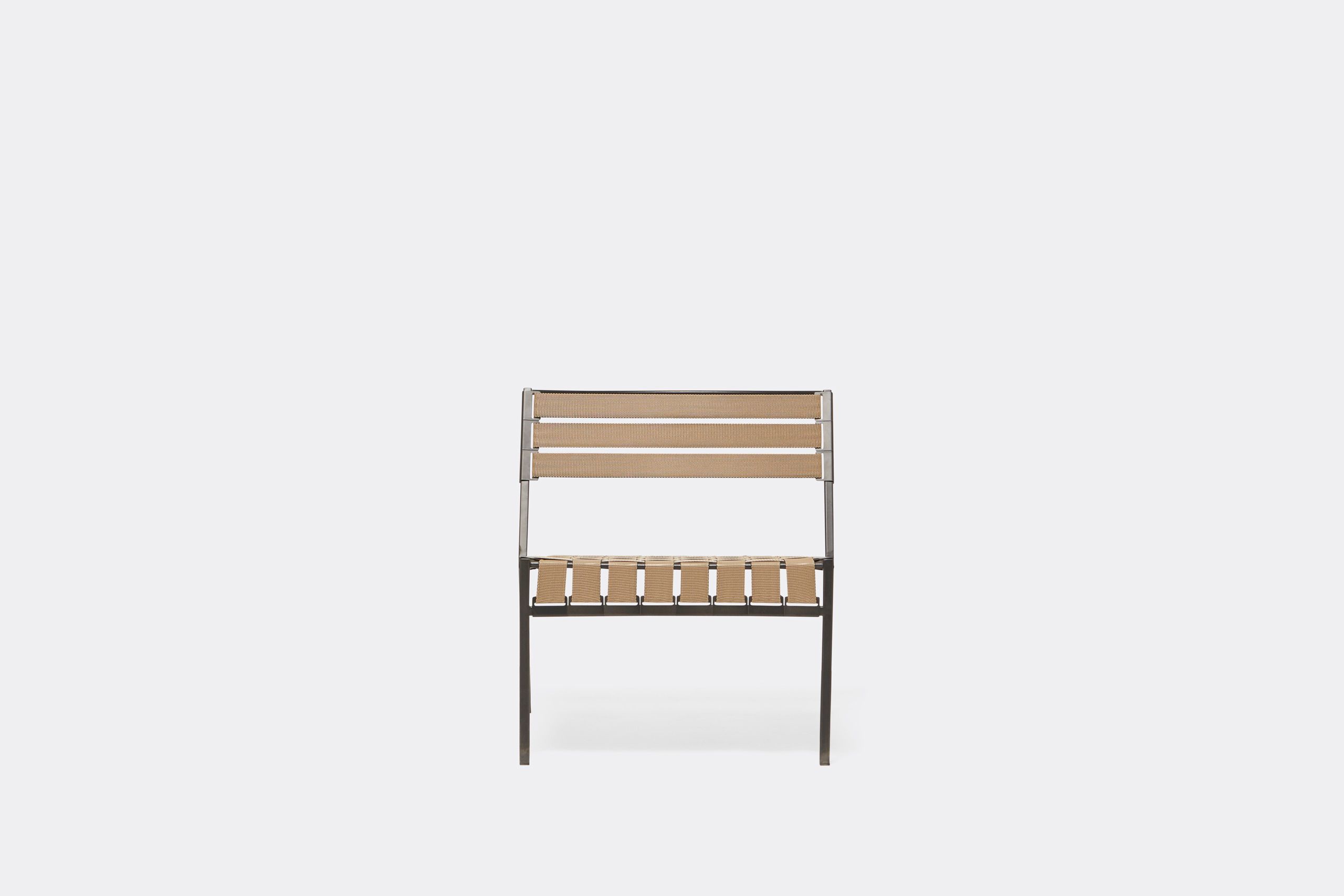 An outdoor steel chair with black metal finish and interwoven tan webbing on a light background