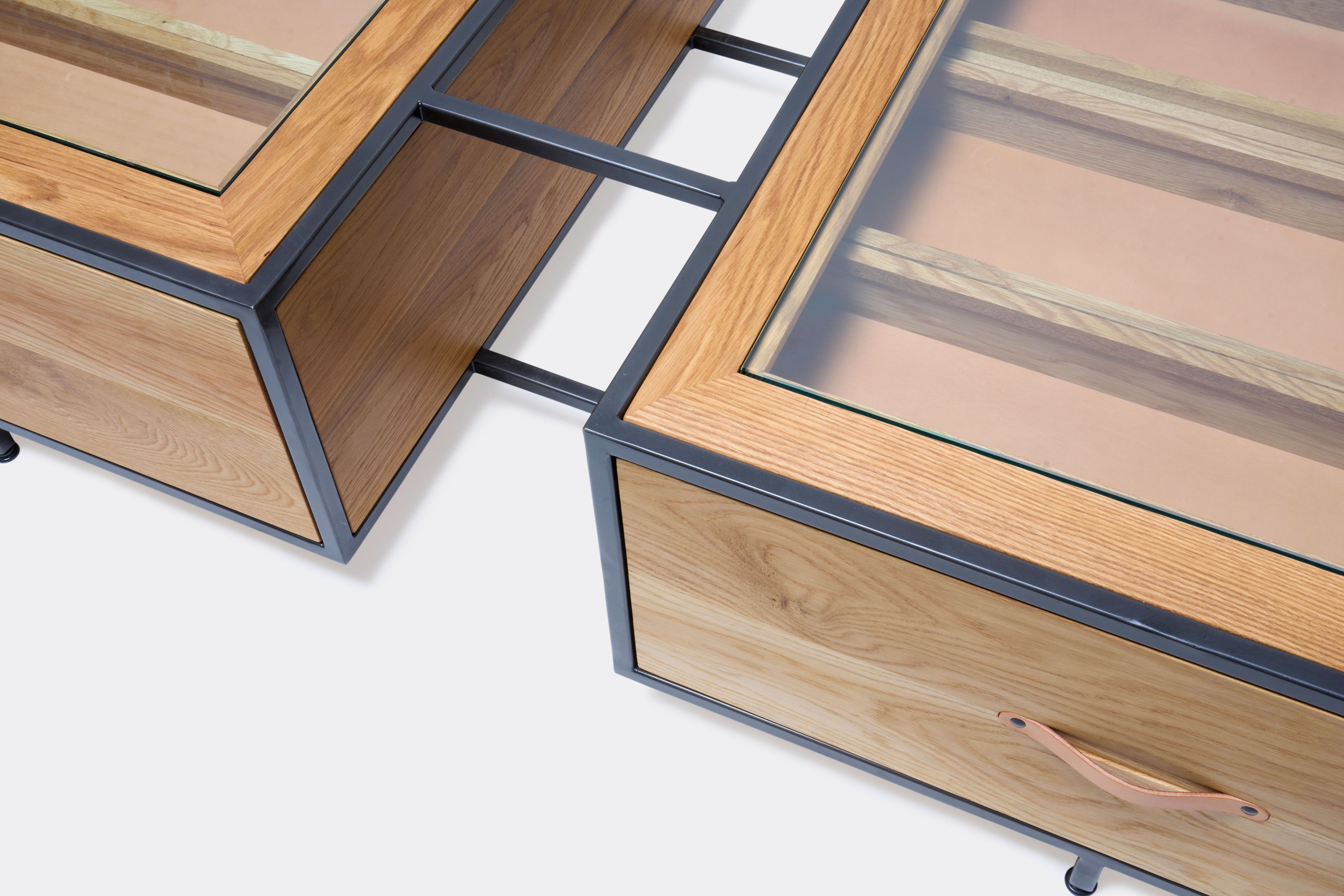 detail of double display coffee table with white oak wood, blackened steel metal and glass top