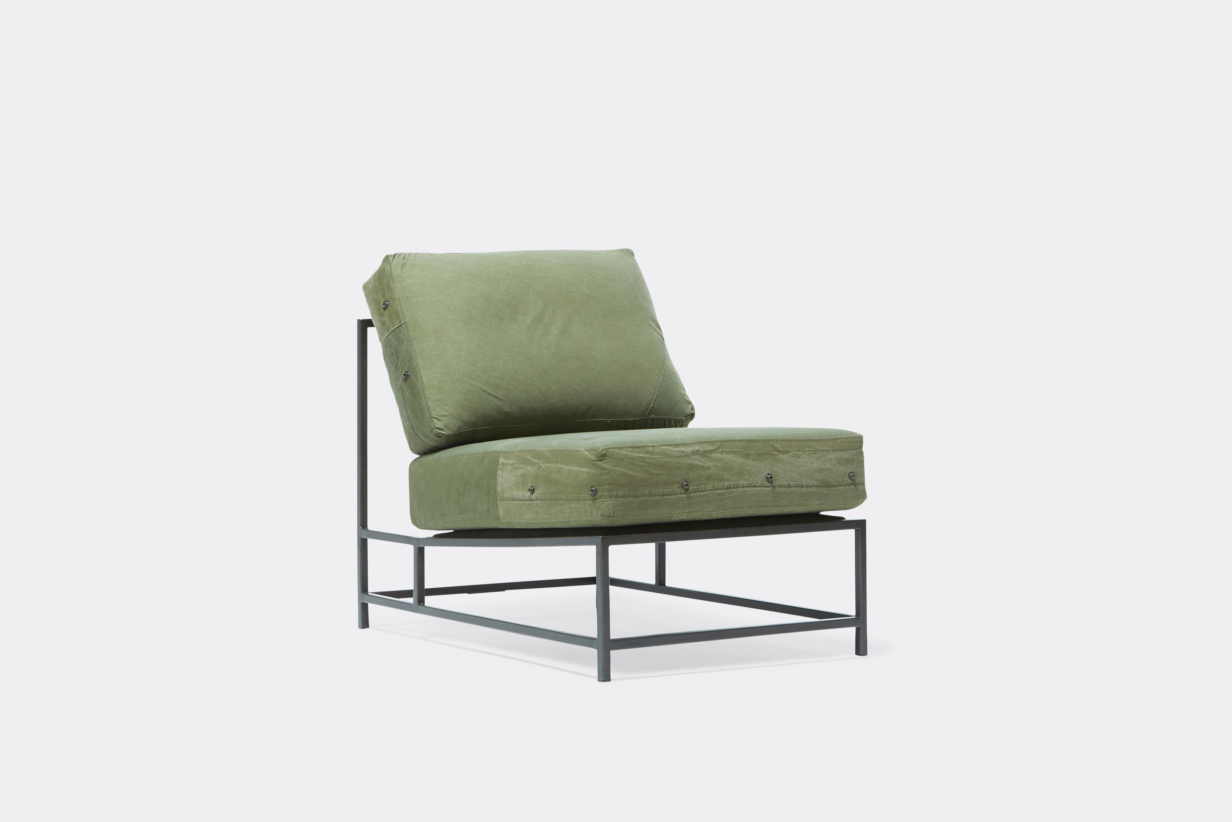 Front of lounge chair with military canvas upholstery and black metal frame