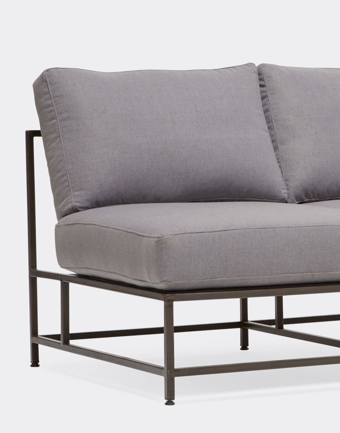 a grey wool sectional with black steel frame shown in various configurations on a white background .