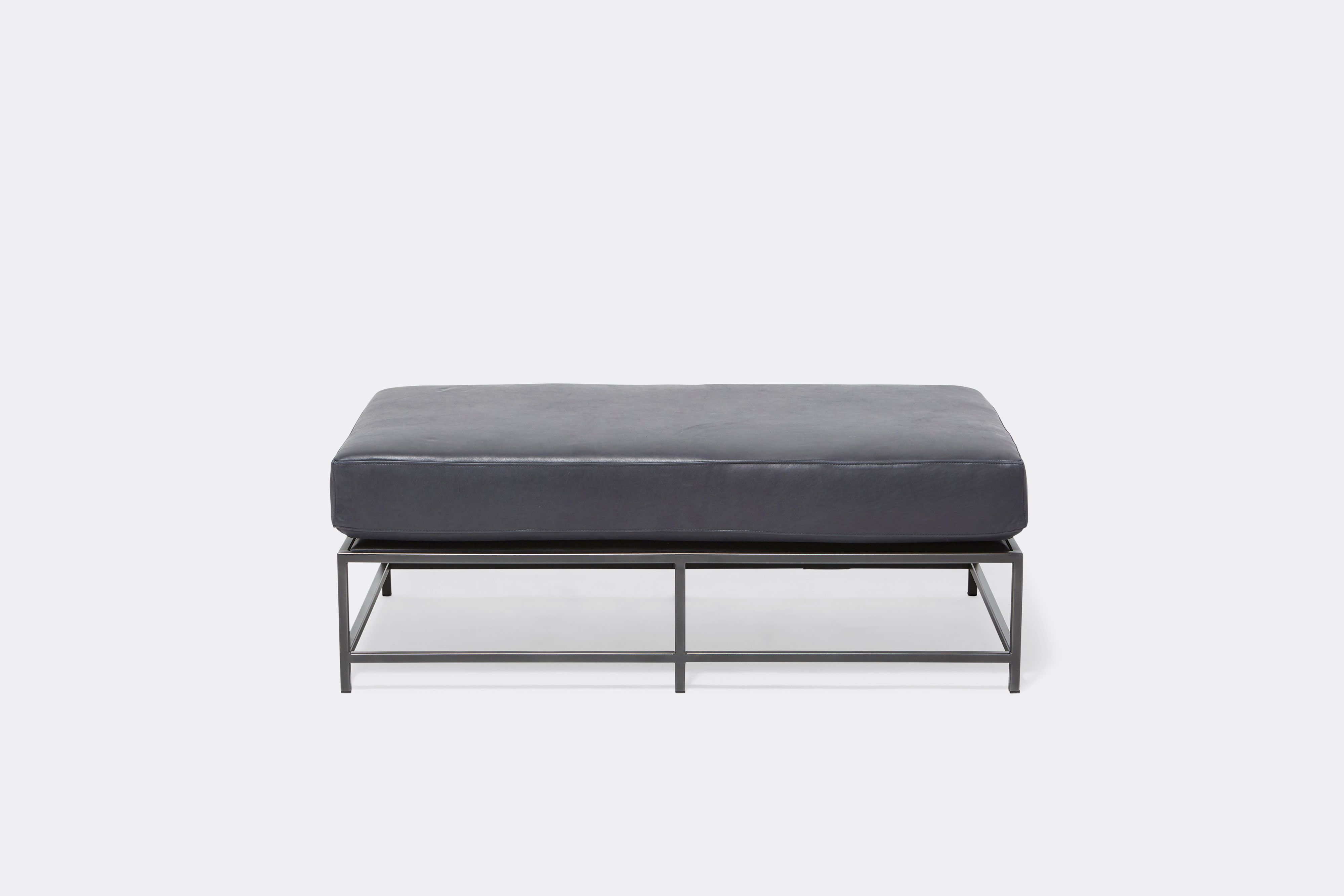 front of bench with blue leather upholstery on black metal frame
