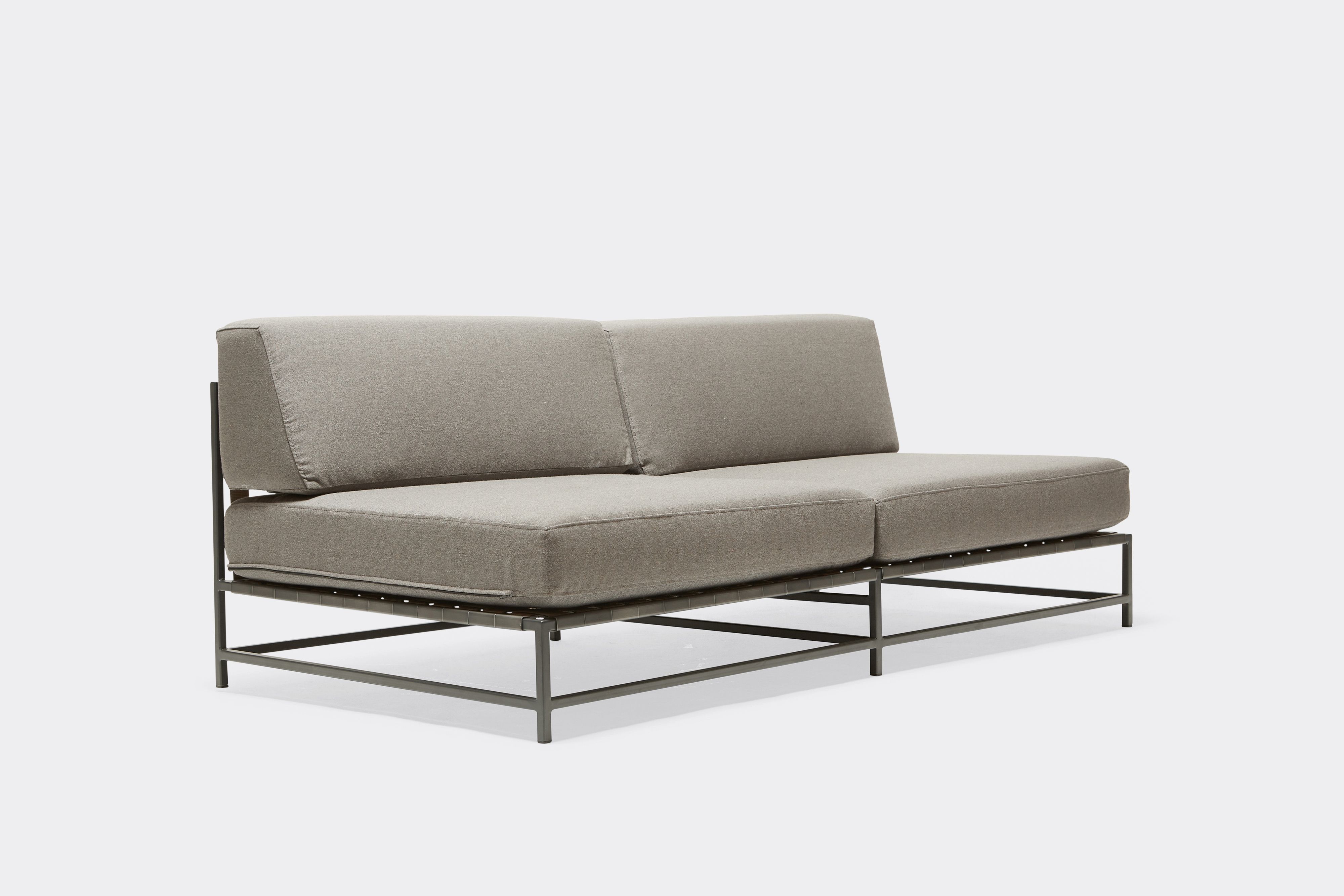 side of outdoor loveseat with grey canvas upholstery on charcoal metal frame
