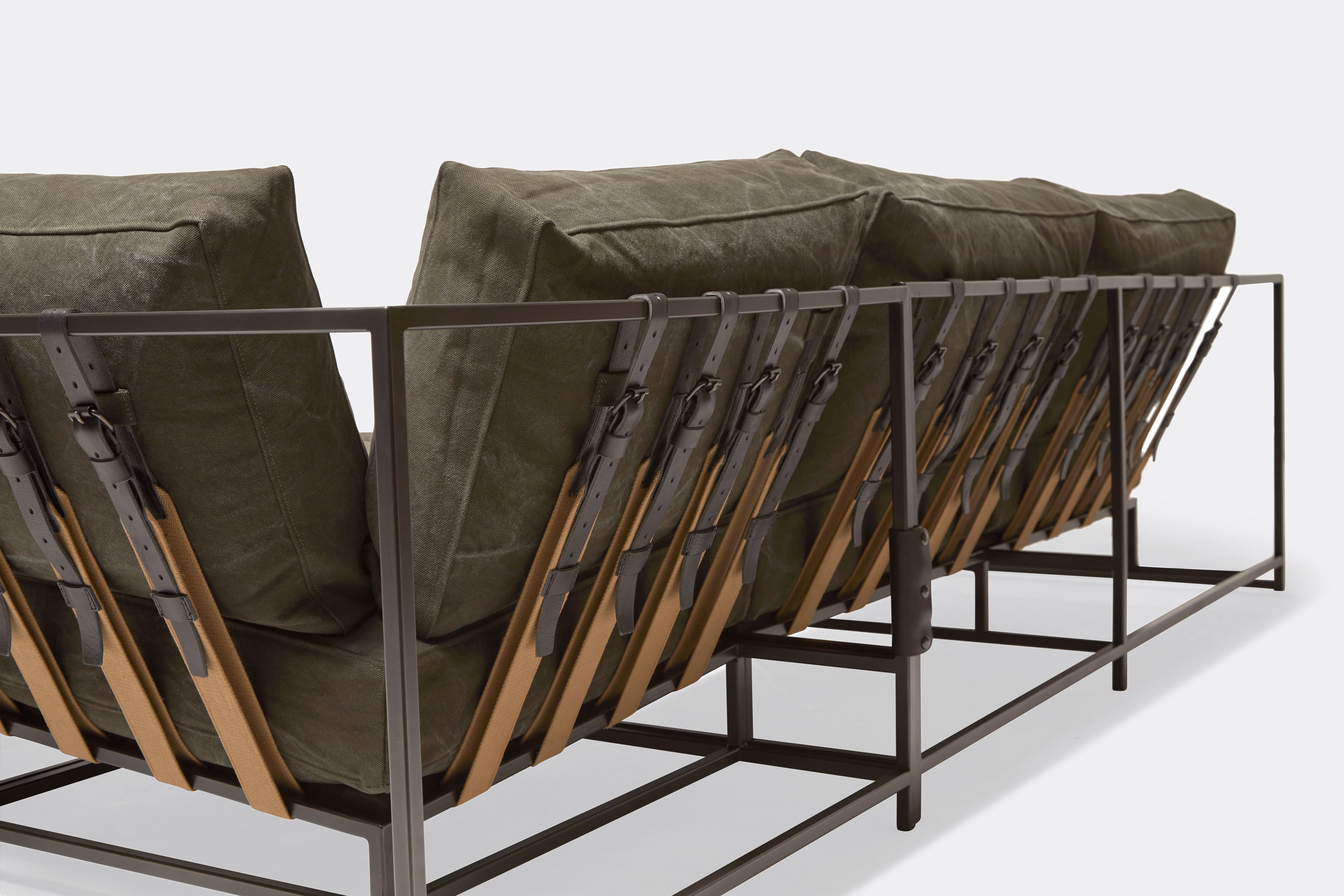 detail of sectional with olive canvas upholstery on blackened steel metal frame