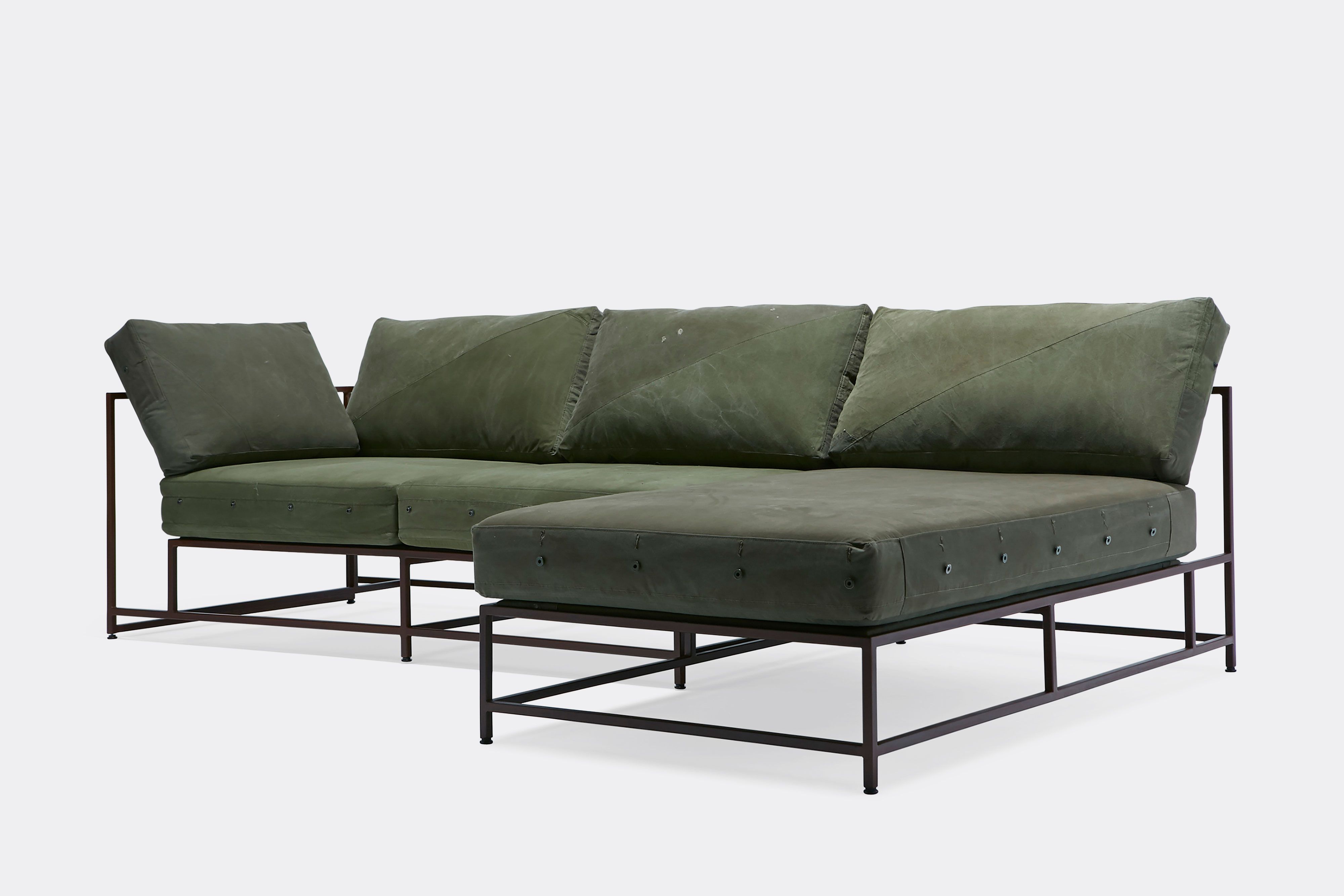 front of sectional with green canvas upholstery on marble rust metal frame