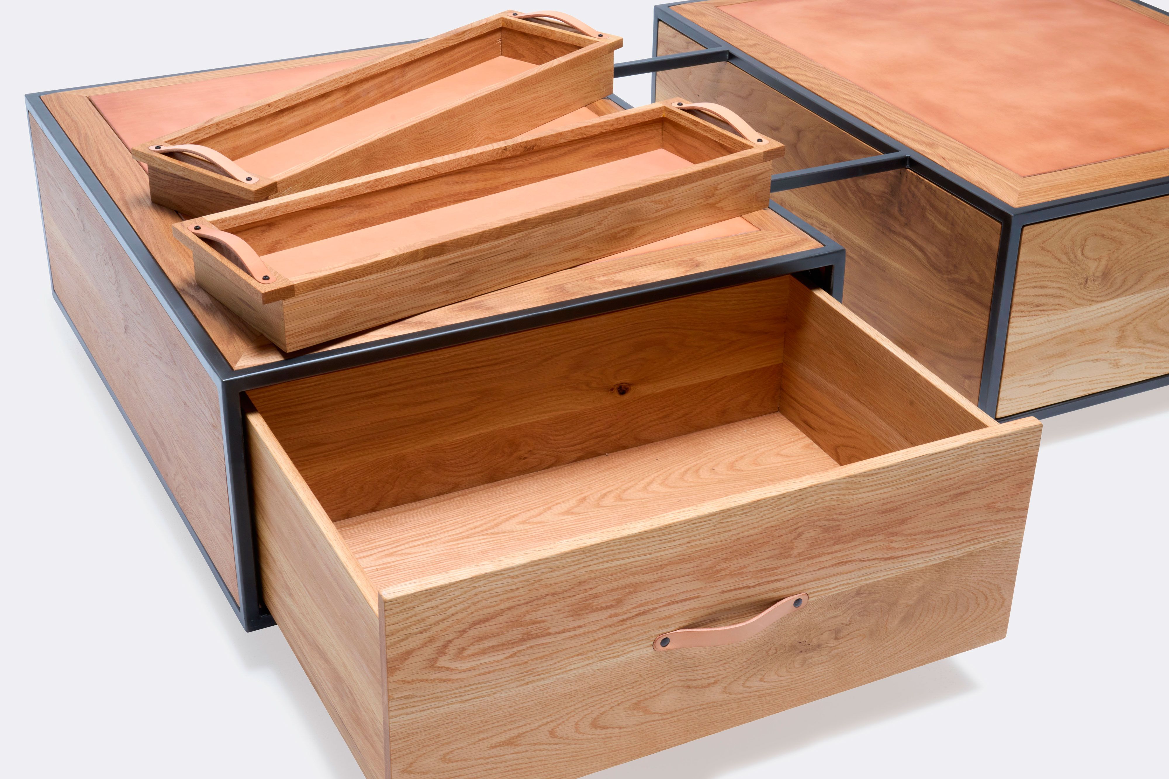 open drawer of double display coffee table with white oak wood, blackened steel metal and leather top