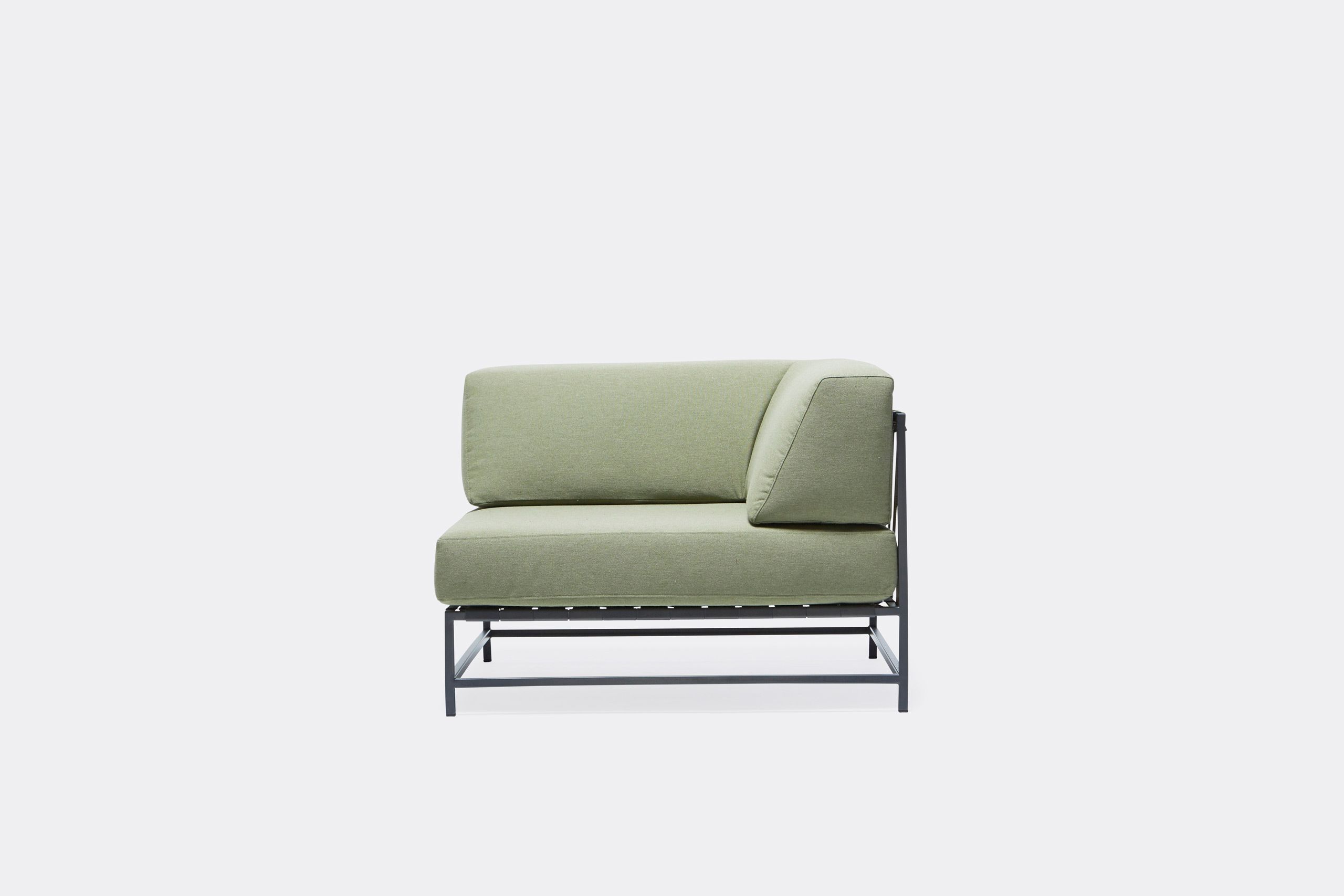 An outdoor chair with steel frame in black finish and green cushions and supporting belts