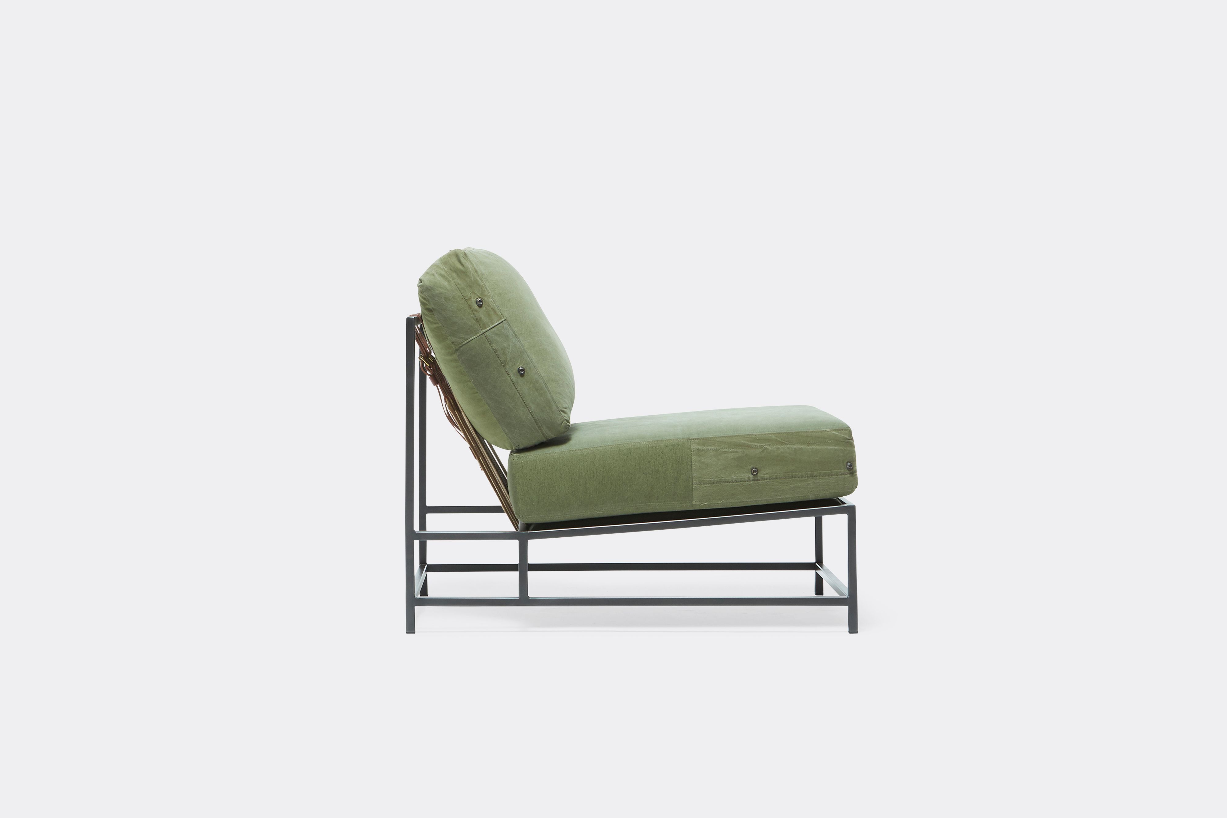 Sideview of lounge chair with military canvas upholstery and black metal frame