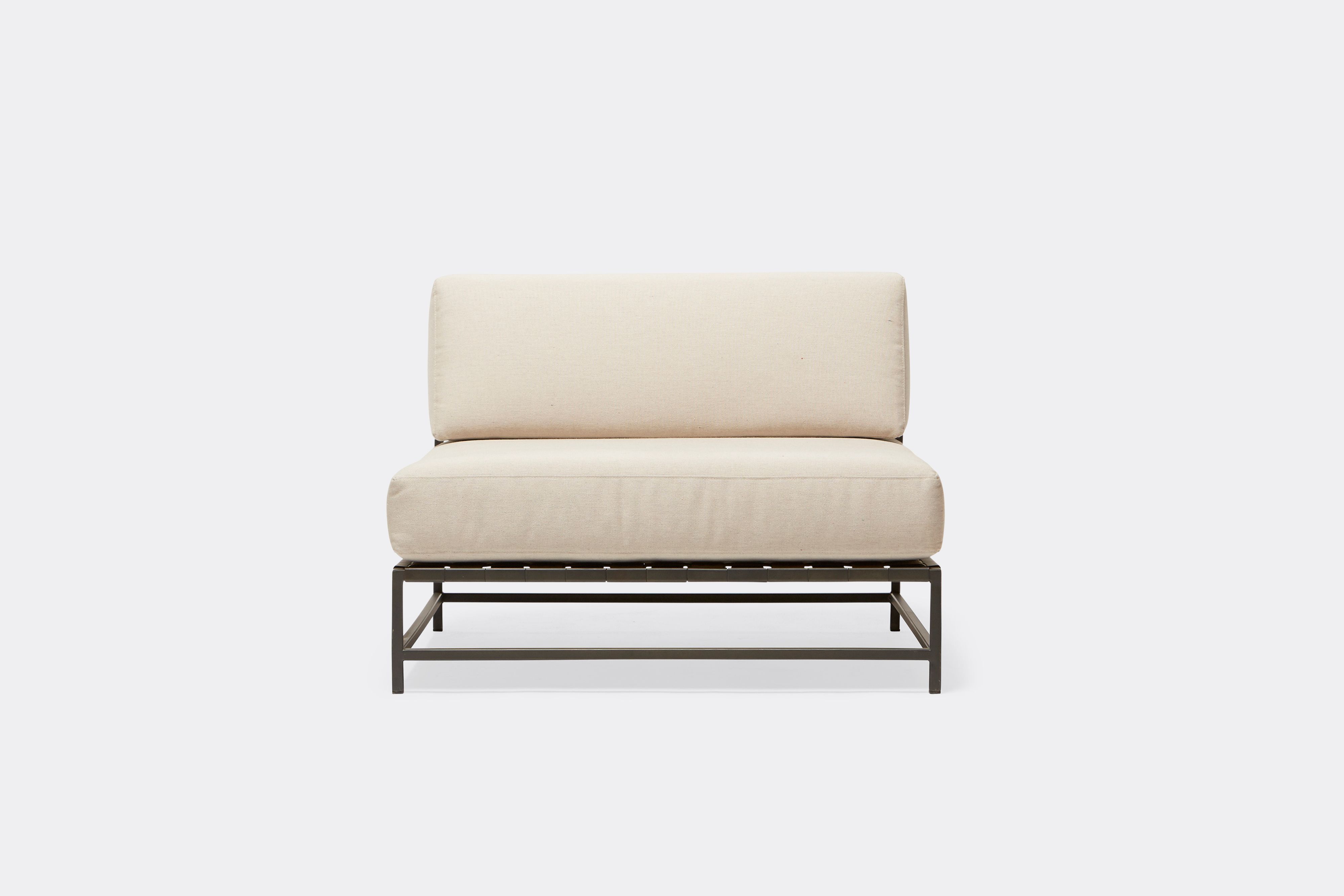 front of outdoor chair with cream canvas upholstery on charcoal metal frame