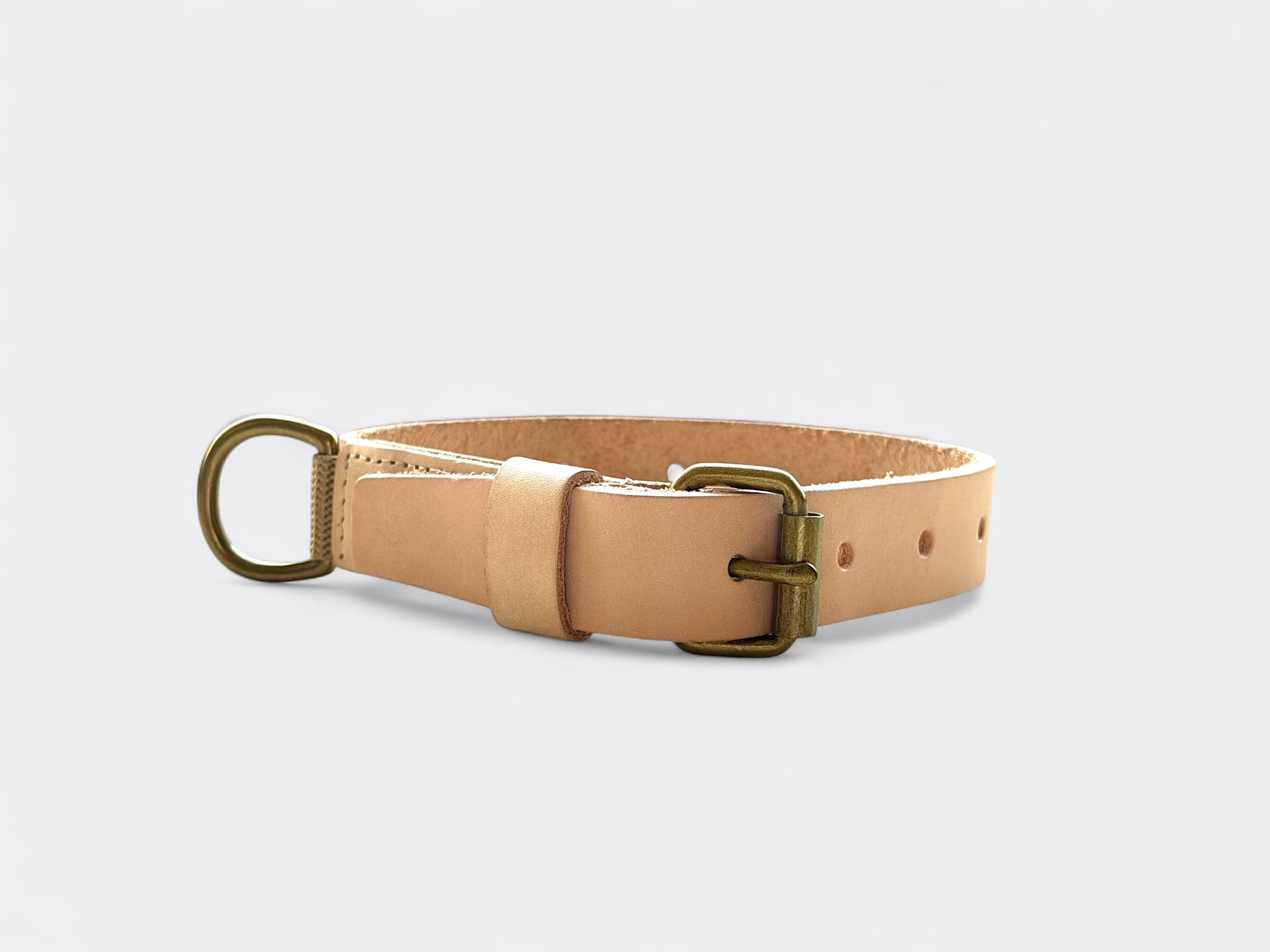 Natural leather dog collar with brass buckle and D-ring.