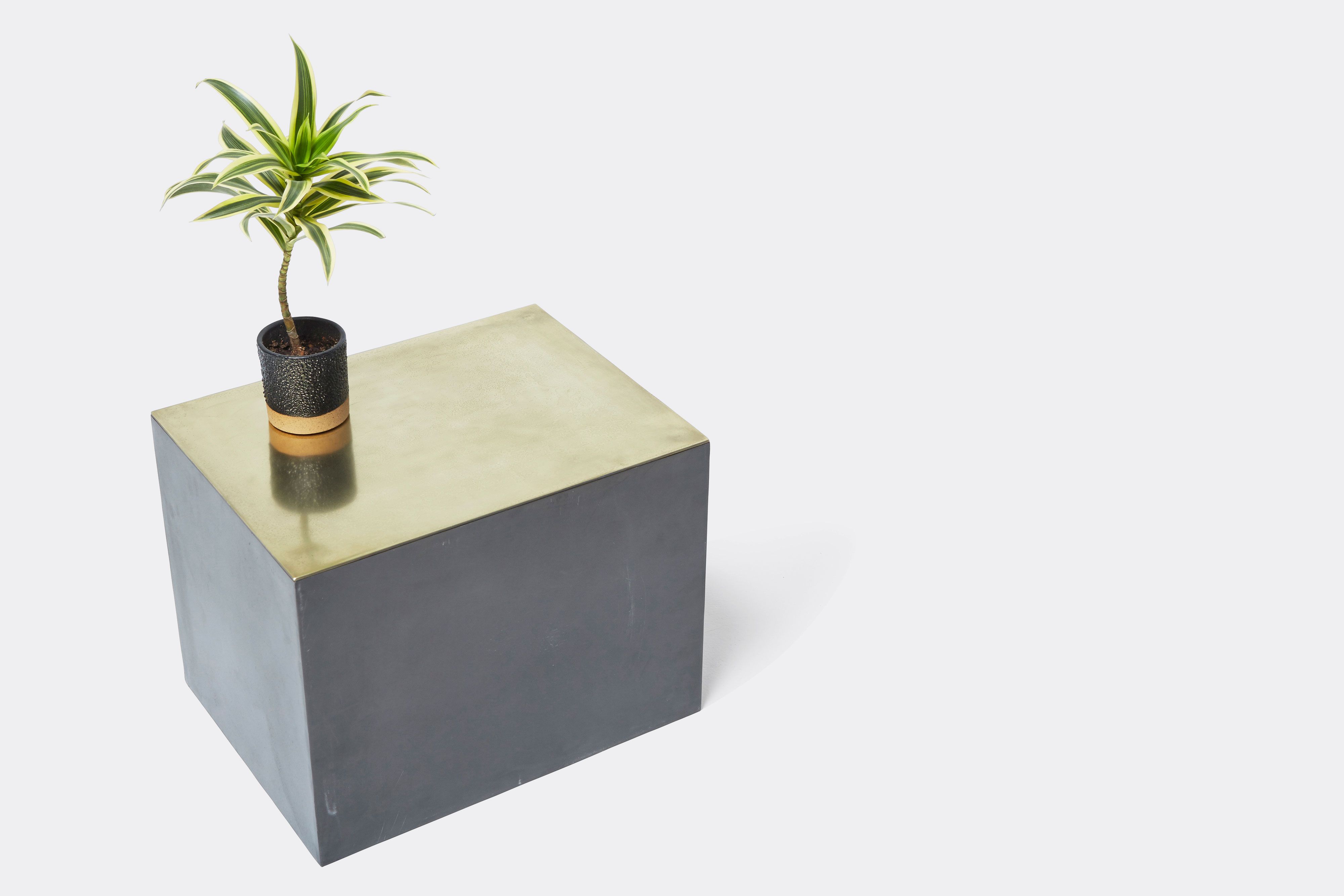 overhead of block table made with tarnished brass and black metal frame