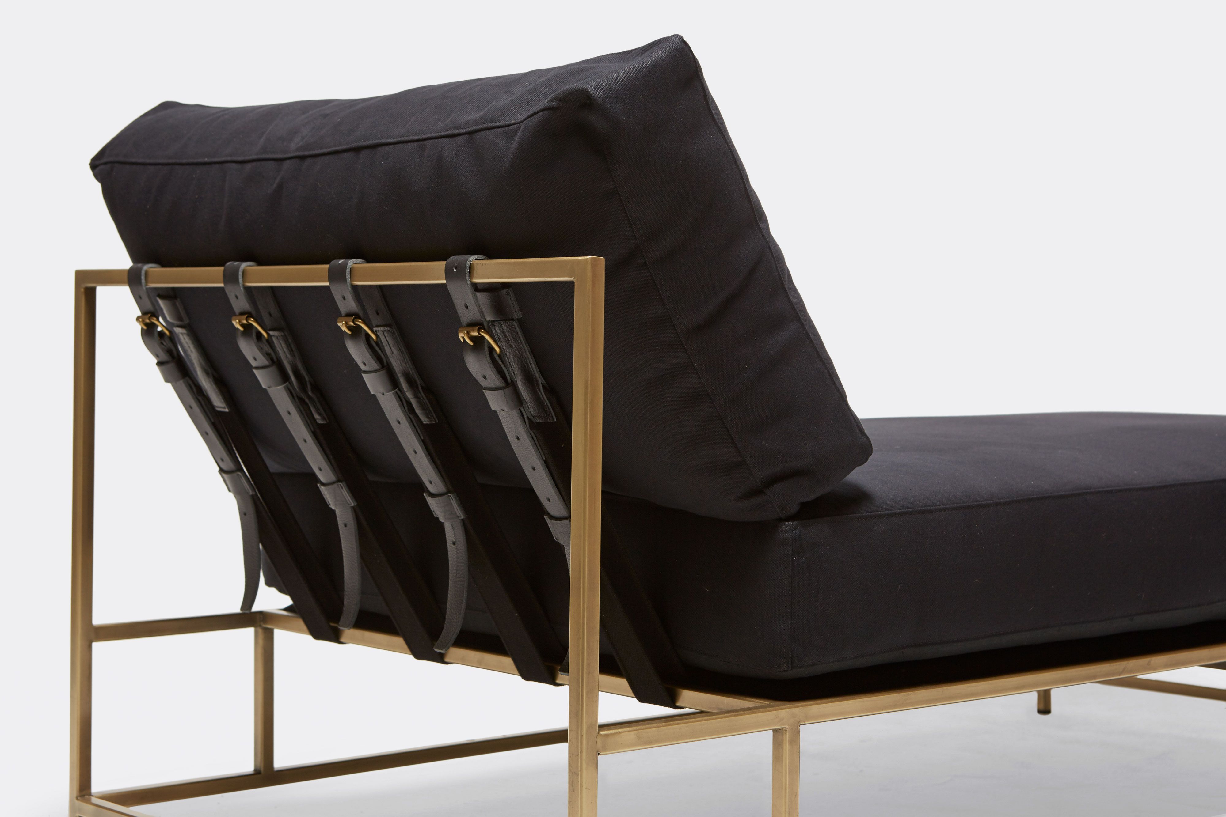 back of Chaise Lounge with black canvas upholstery and black leather belts on antique brass metal frame