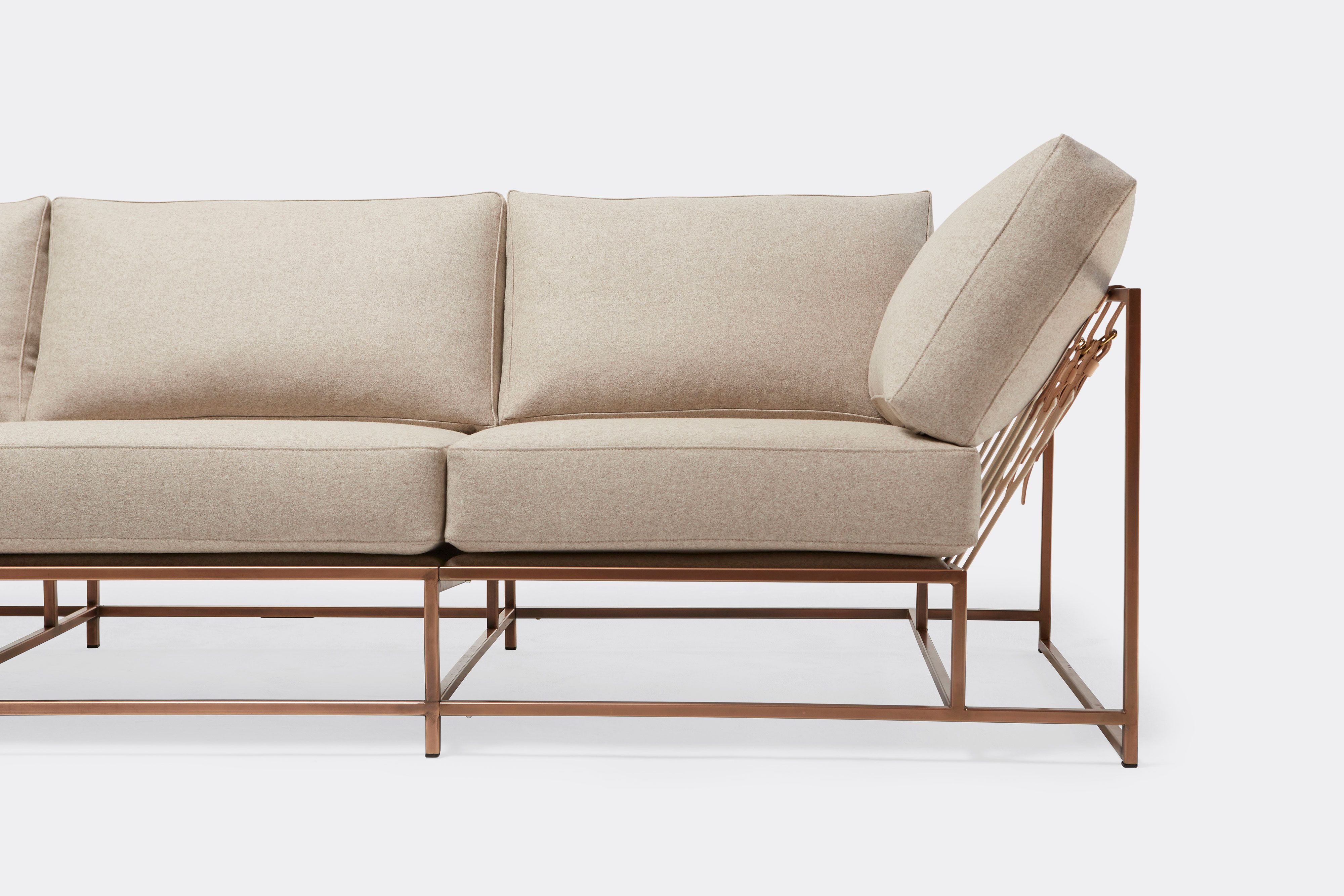 front of three piece sofa with cream wool upholstery on antique copper metal frame