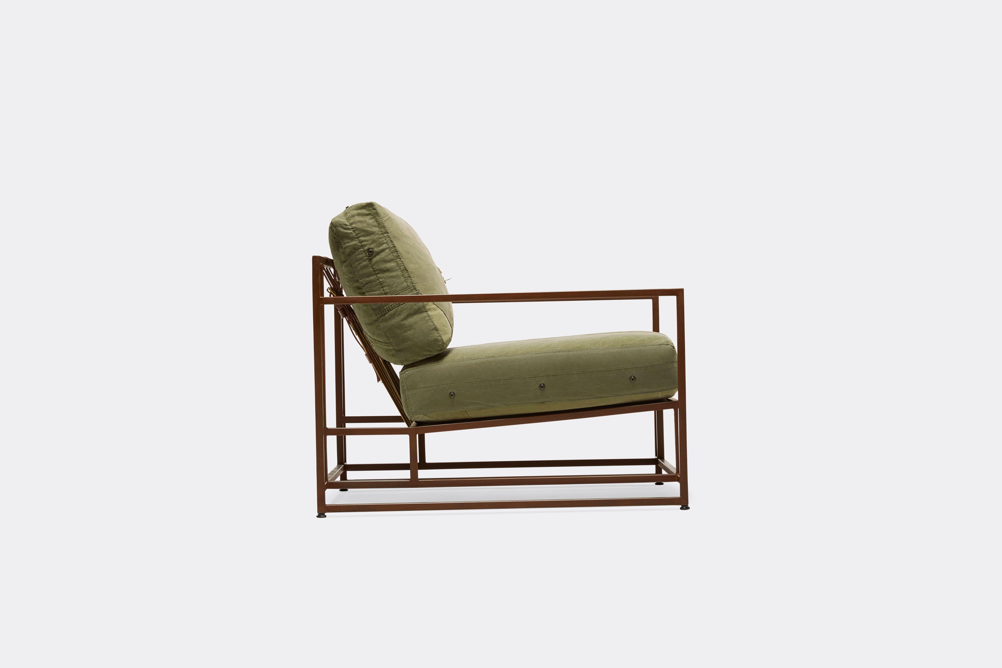side of armchair with green canvas upholstery on marbled rust metal frame