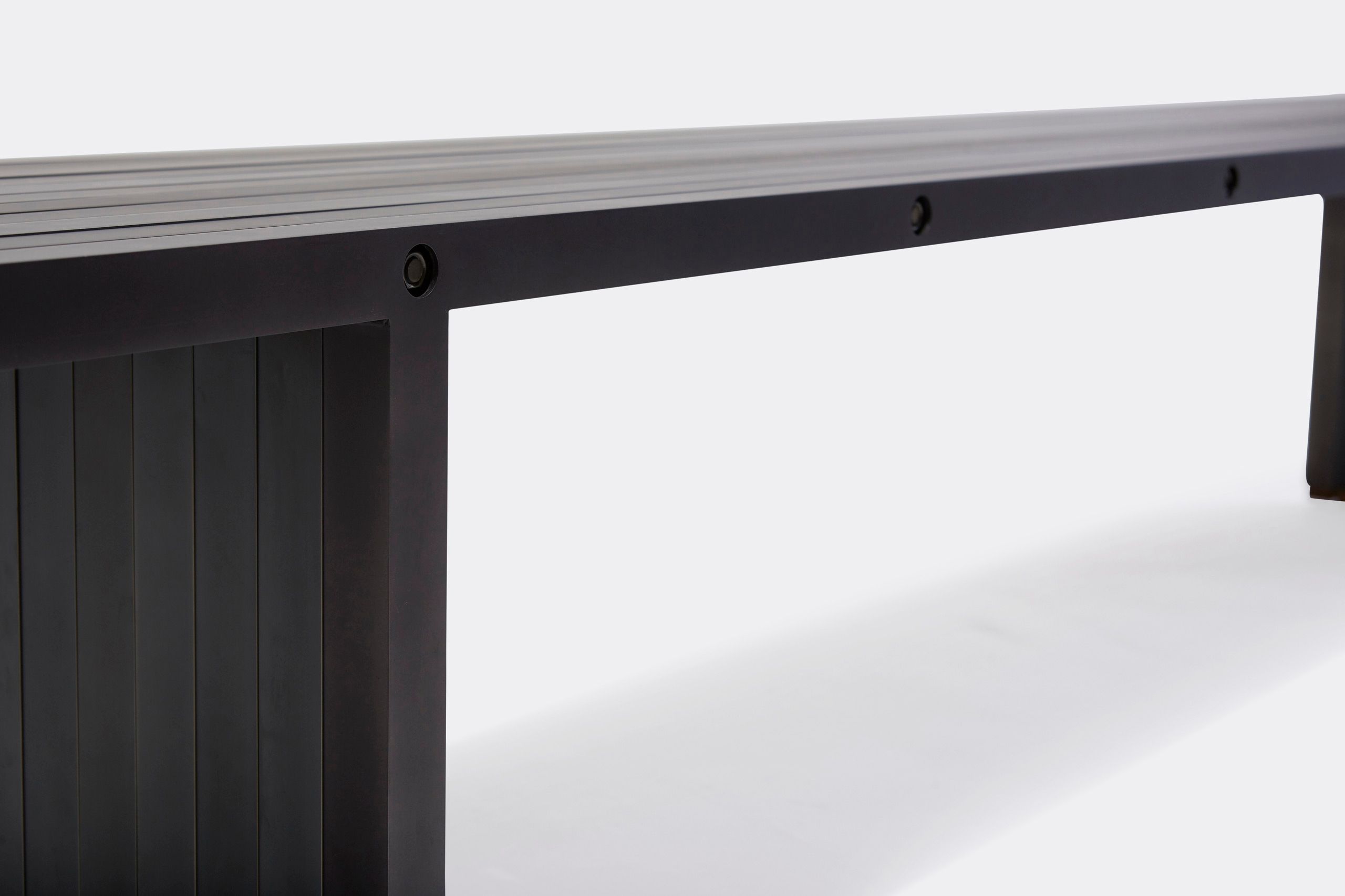 a black aluminum bench on a white background .