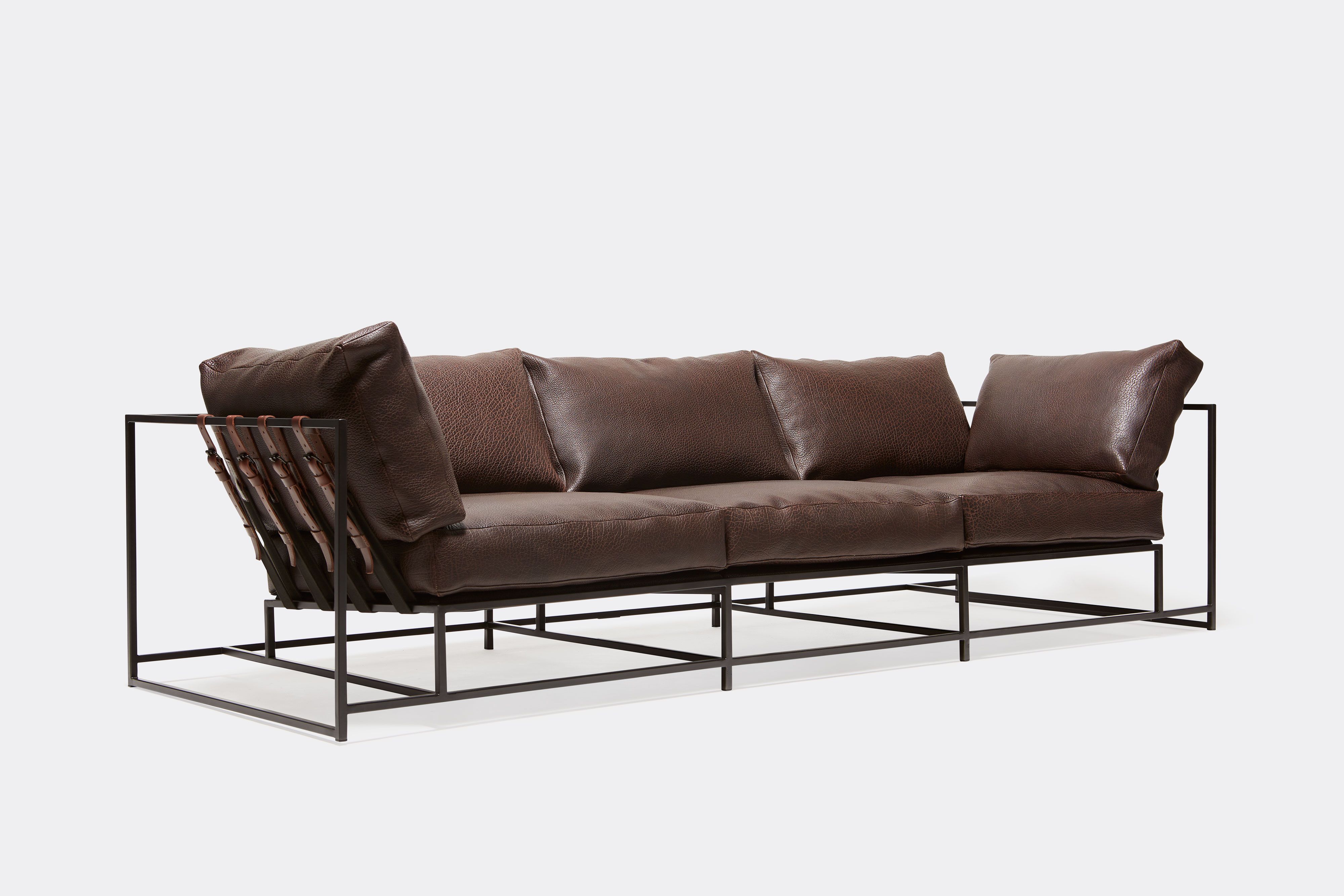 Front view of brown leather sofa with blacken steel metal frame and leather belts.