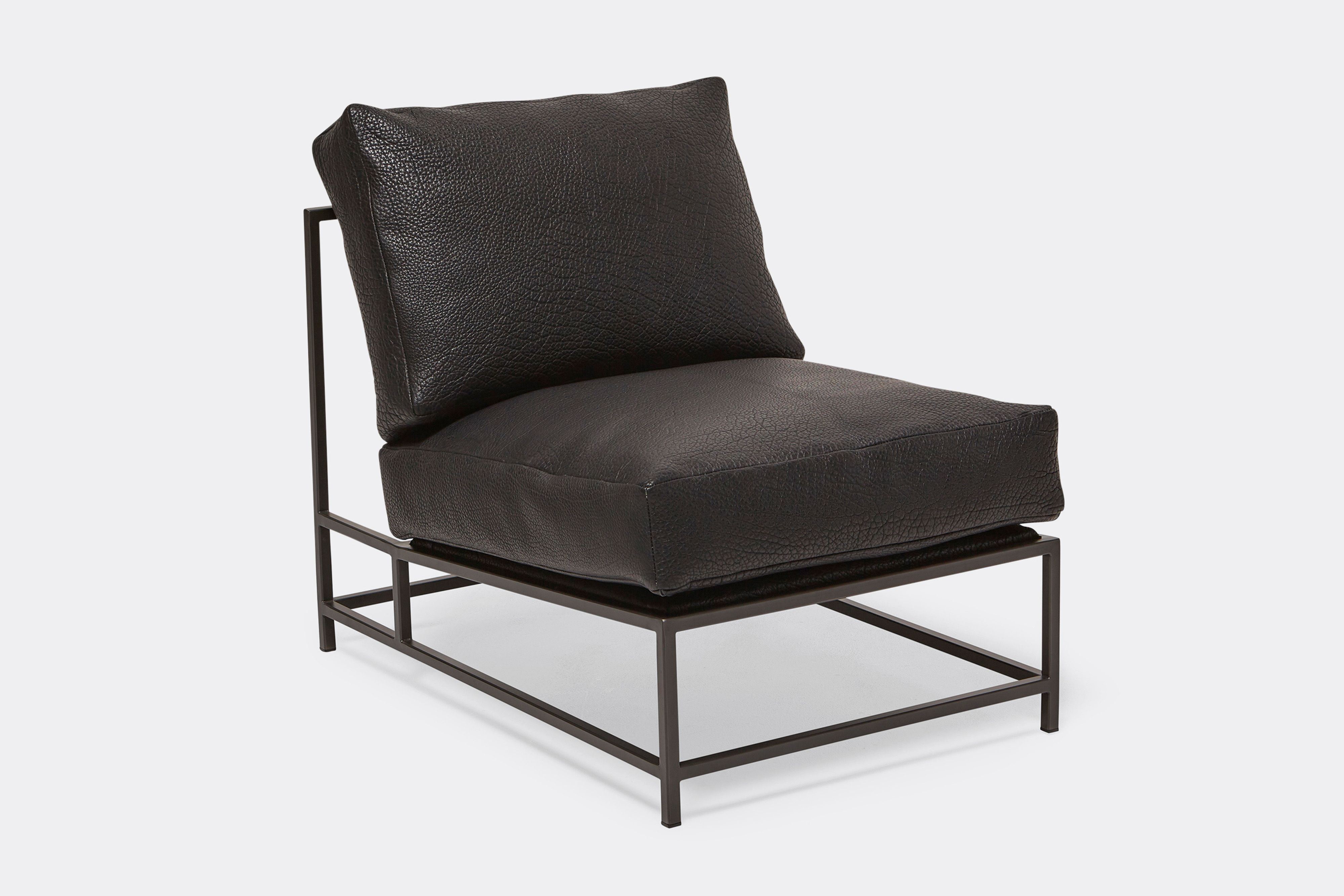 Front of lounge chair with black leather upholstery and black metal frame