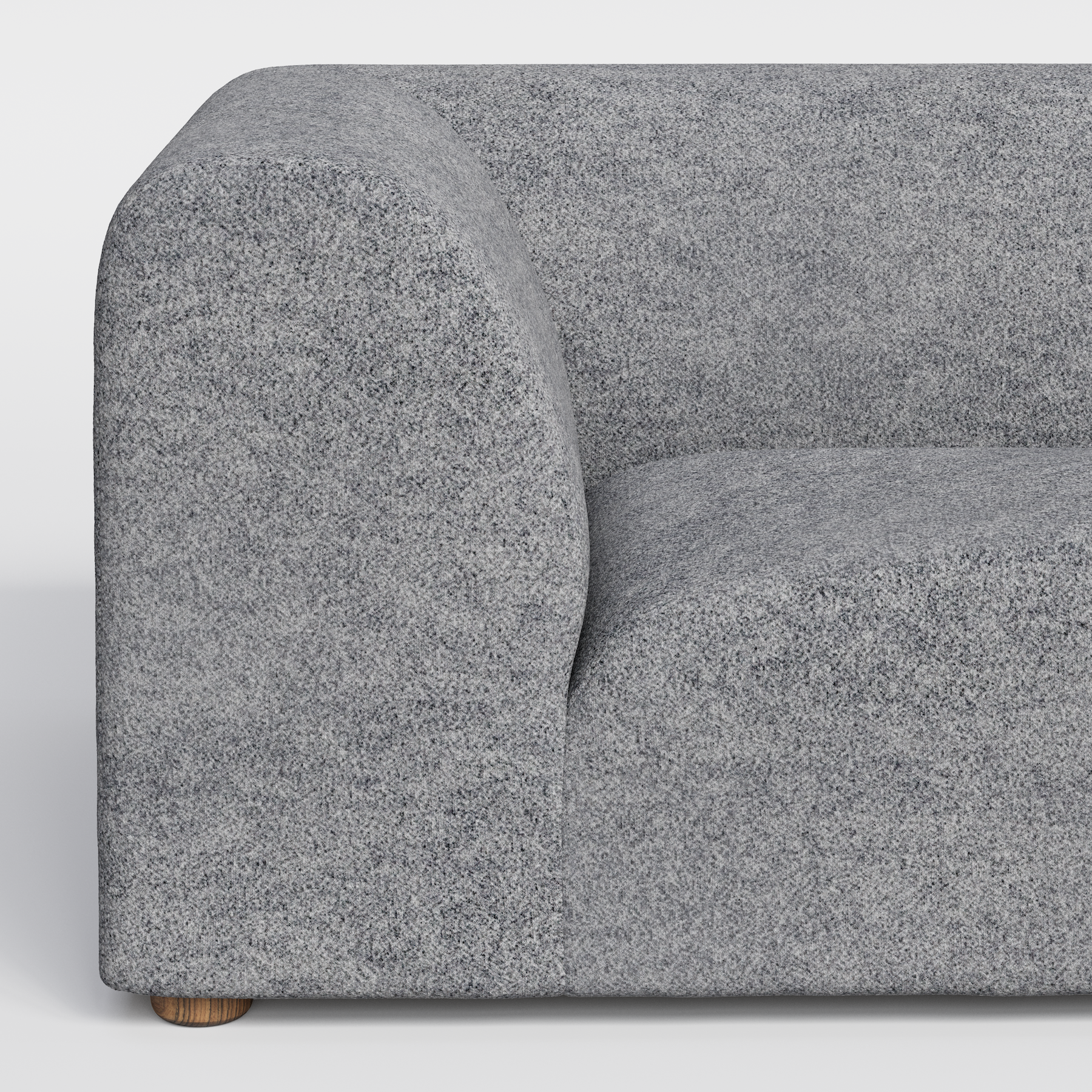 Close-up of a gray textured sofa with a rounded armrest and a wooden leg.
