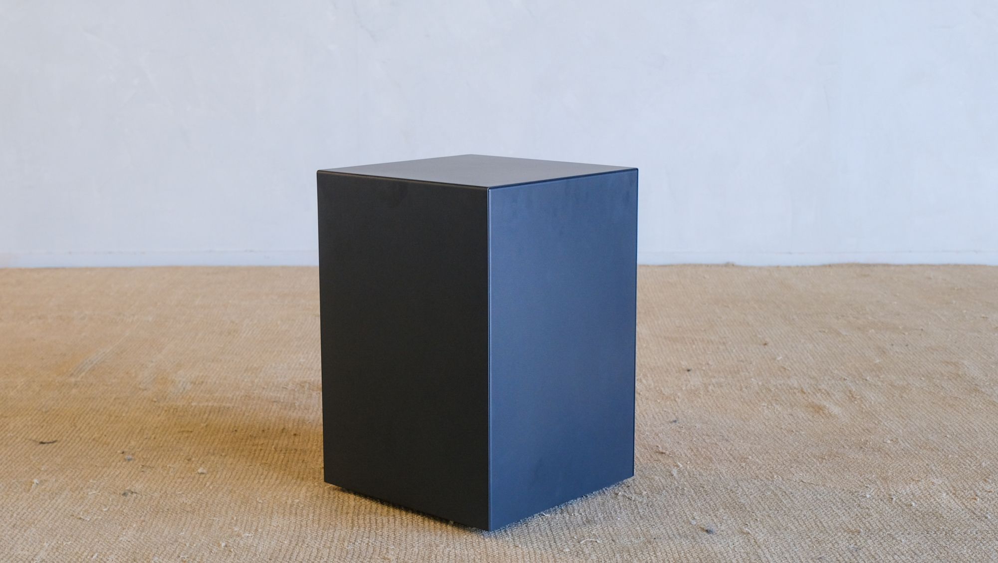 a black cube is sitting on a table .