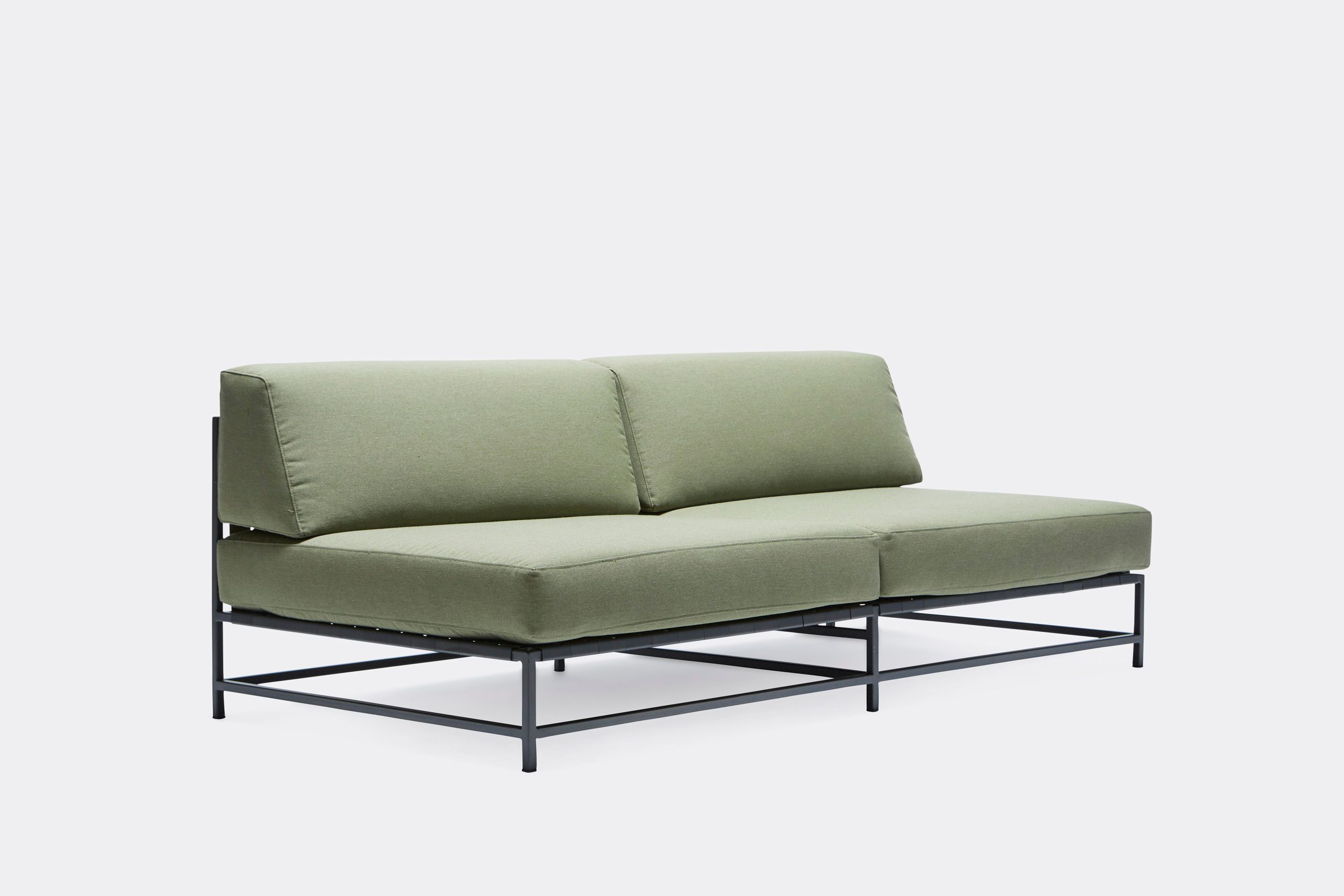 a steel framed sofa with black metal finish and green cushions and supporting belts on a white background .