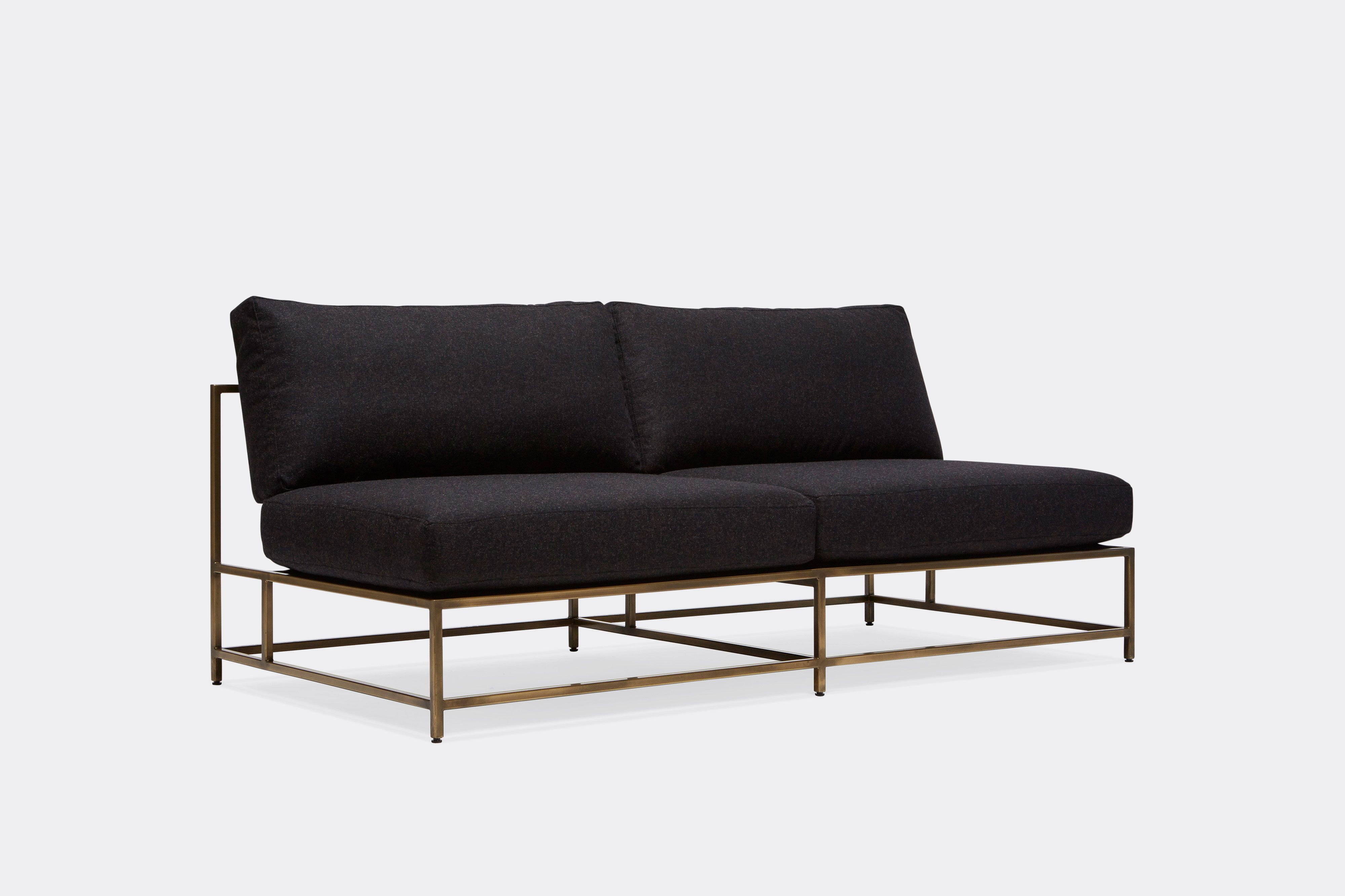 side of loveseat with black wool upholstery on antique brass metal frame