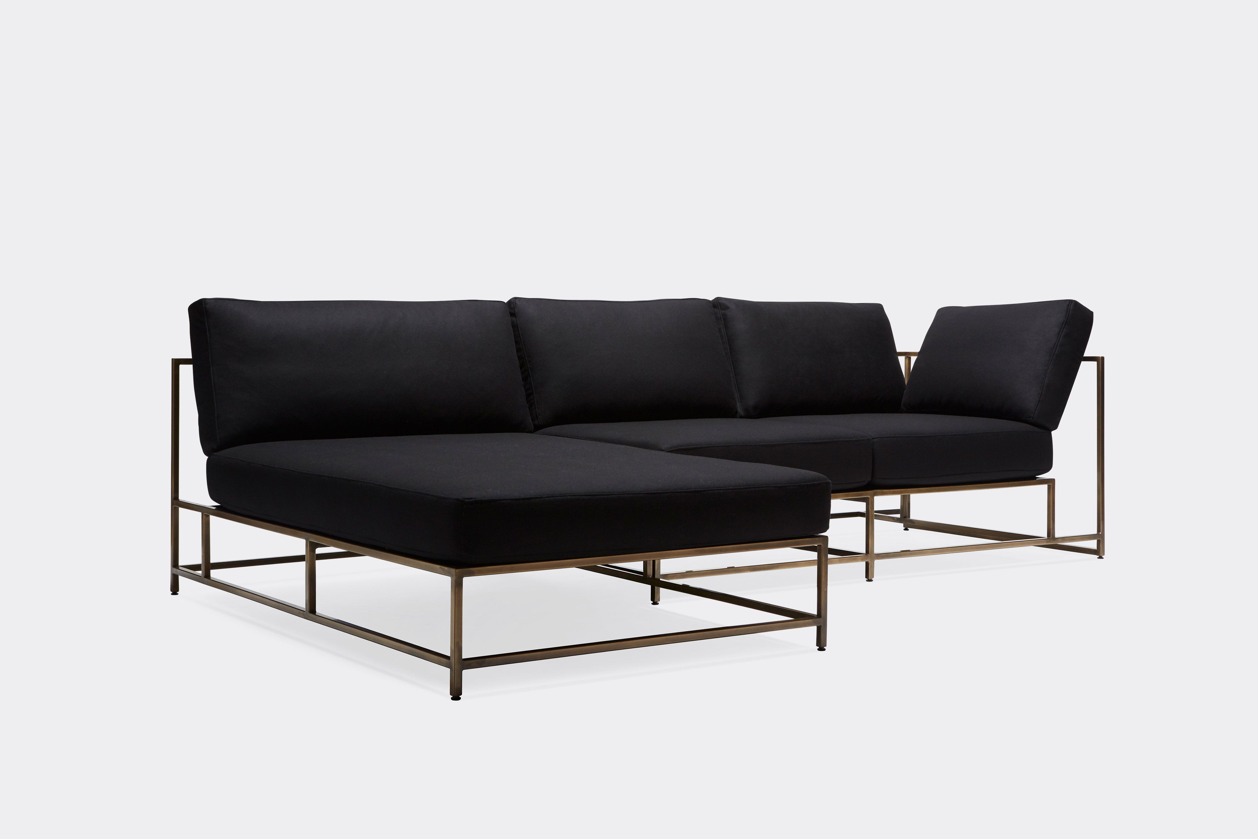 front of sectional with black wool upholstery on antique brass metal frame